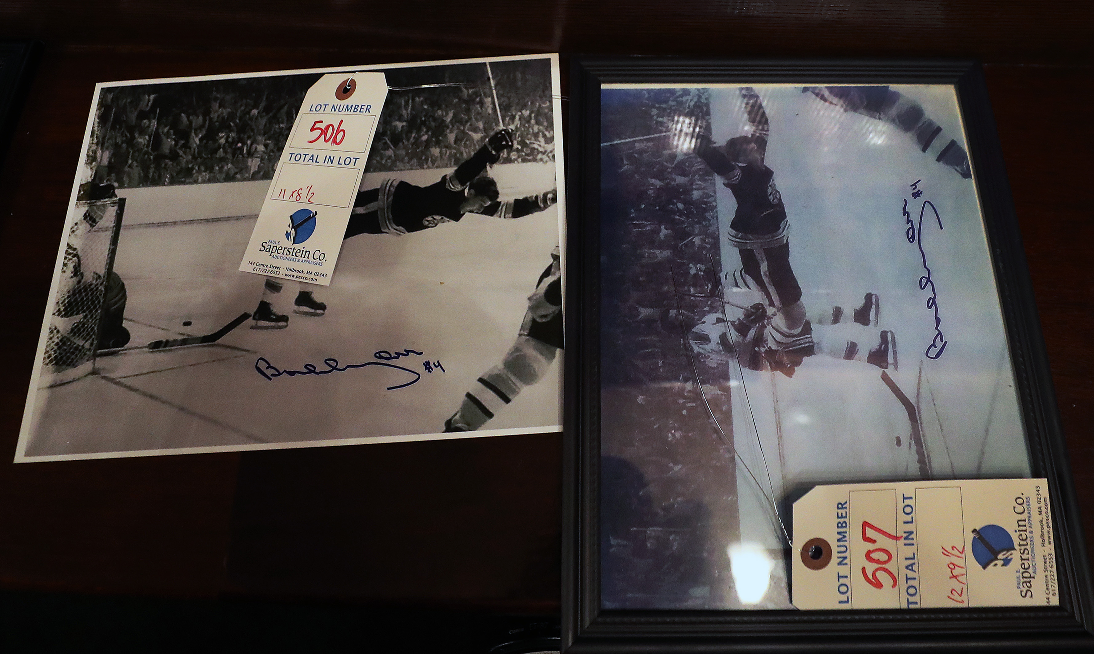 Autographed copies of Ray Lussier's famous photo of Bobby Orr flying through the air after he scored the winning goal in the 1970 Stanley Cup are among the memorabilia items from the walls of The Fours that can be purchased in auction.