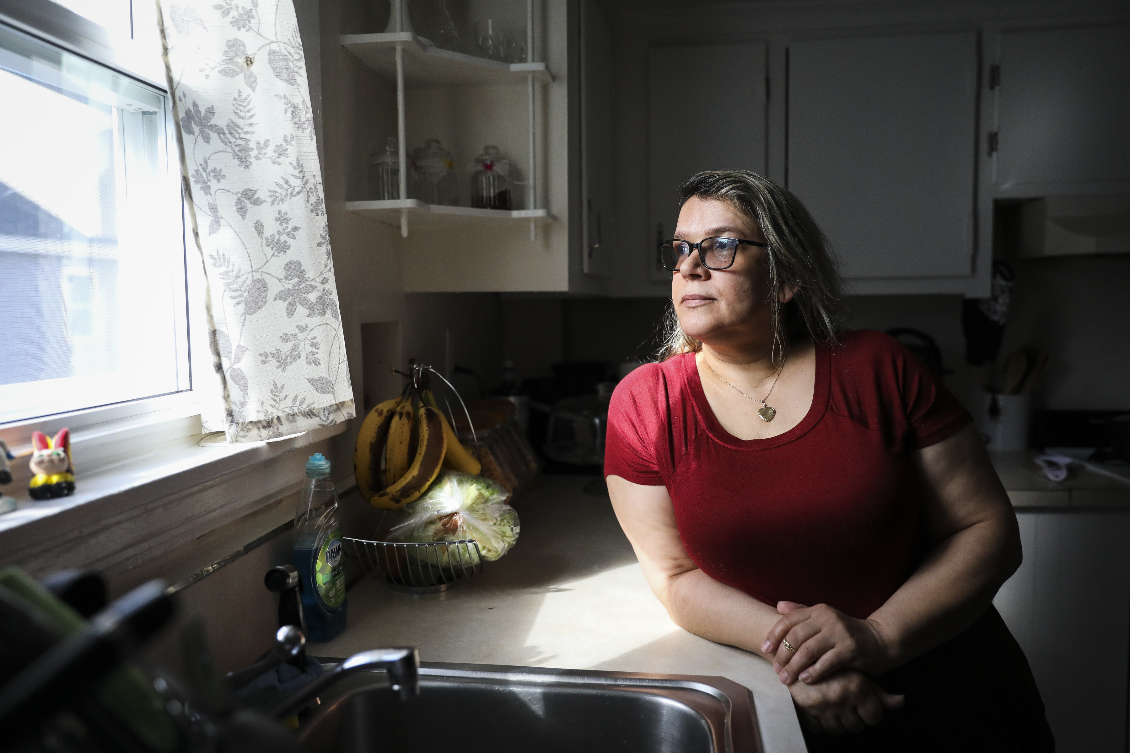 MEDFORD - 3/24/2020:  Vanderleia da Silva poses for a portrait in her Medford apartment. Originally from Brazil, da Silva has lived in the Boston area for over 20 years while working as a house cleaner. However, after the coronavirus has spread across the state, da Silva has lost most of her clients. (Erin Clark/Globe Staff)