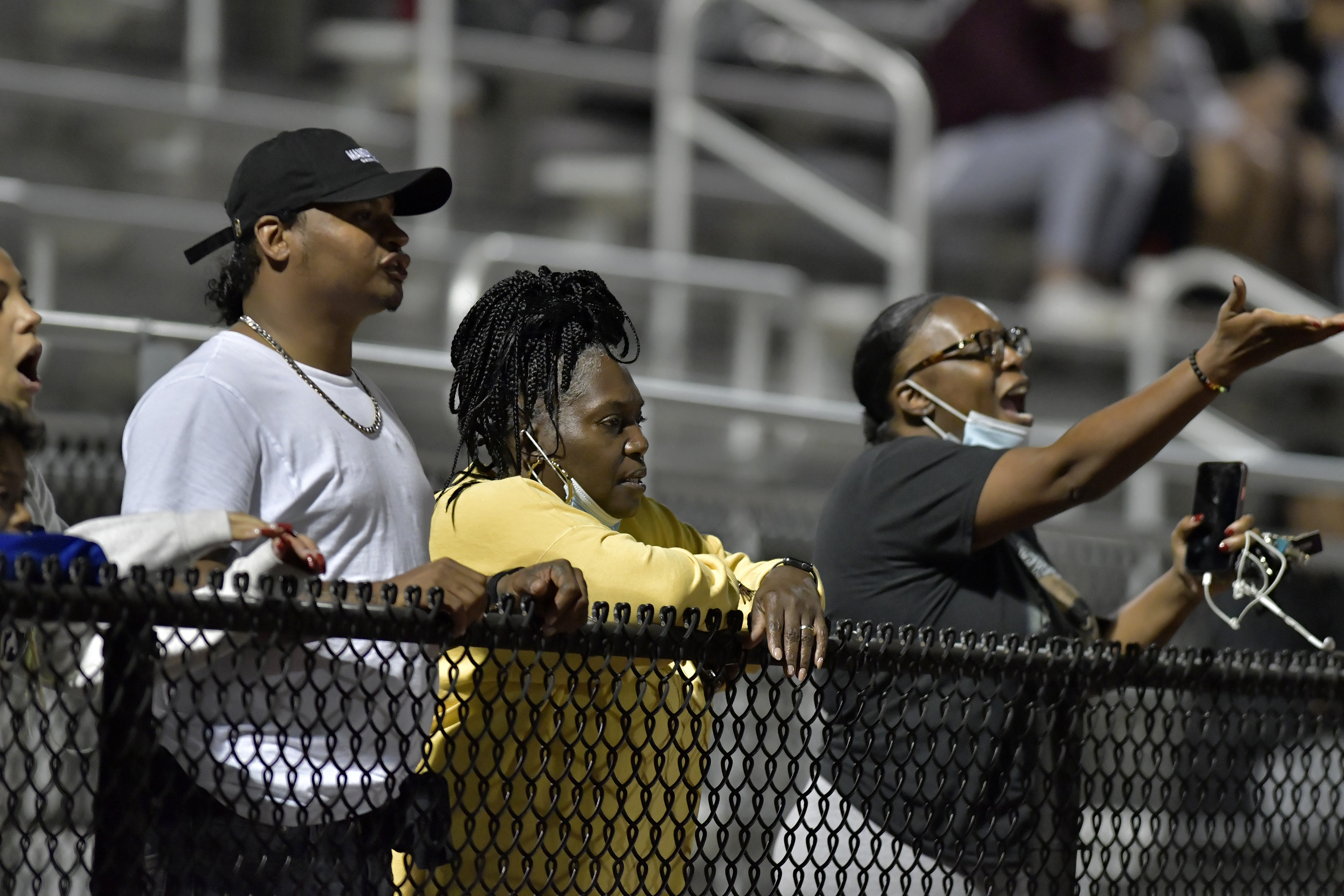 From left, Roxbury Prep parents Larry Fisher, Deborah Manago, and Missy Brown look on as Roxbury Prep hosts Millis at West Roxbury High on Sept. 24, a week after a skirmish broke out late in Georgetown High's game against Roxbury Prep. Roxbury Prep alleges racial slurs prompted the fight.