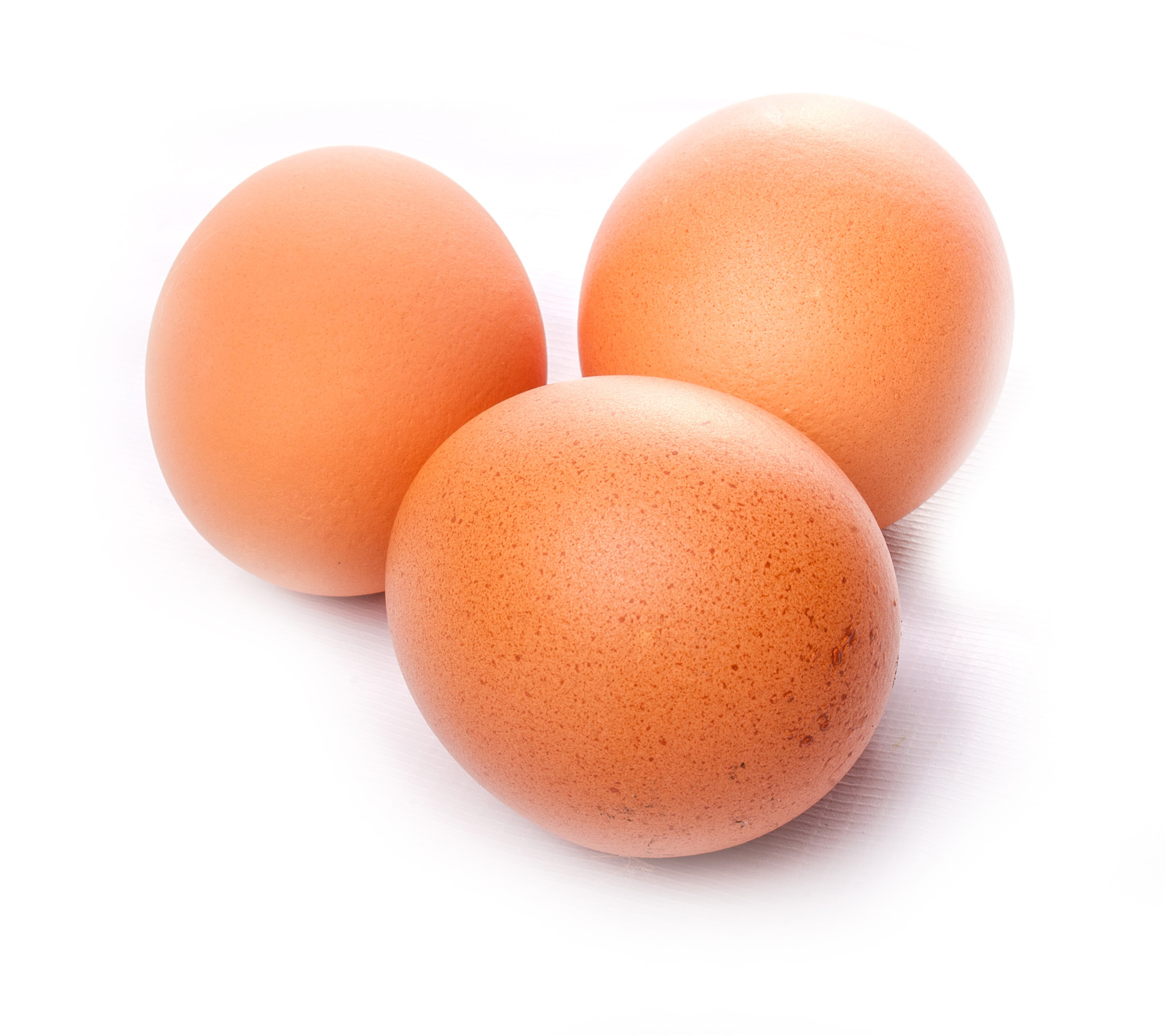 Three chicken eggs isolated on white background