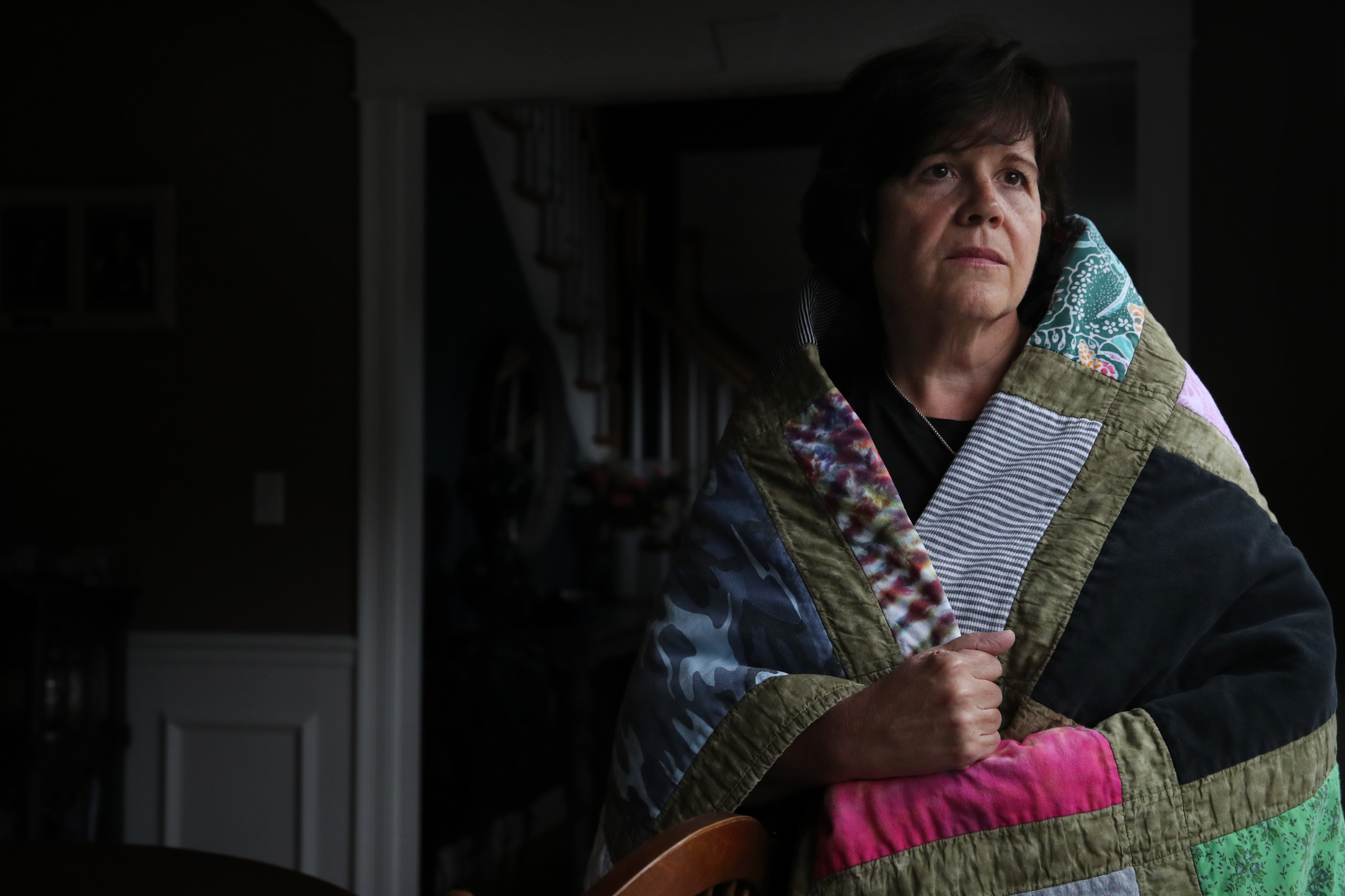 Jeannine Daly wrapped herself in a quilt made of her sisters T-shirts.