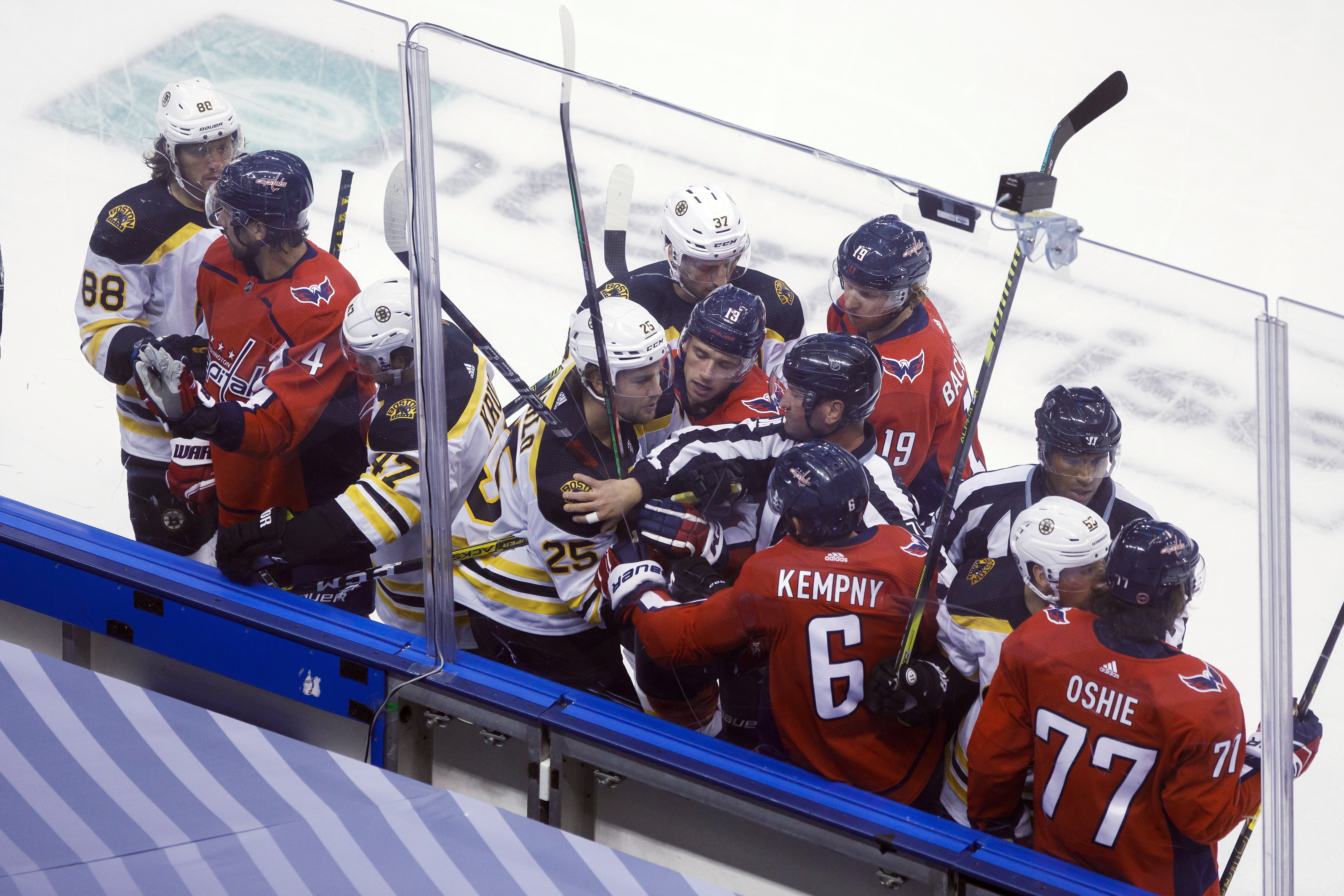 Referees and players try to separate Brandon Carlo (25) and Washington's Michal Kempny (6) during first-period action on Sunday.