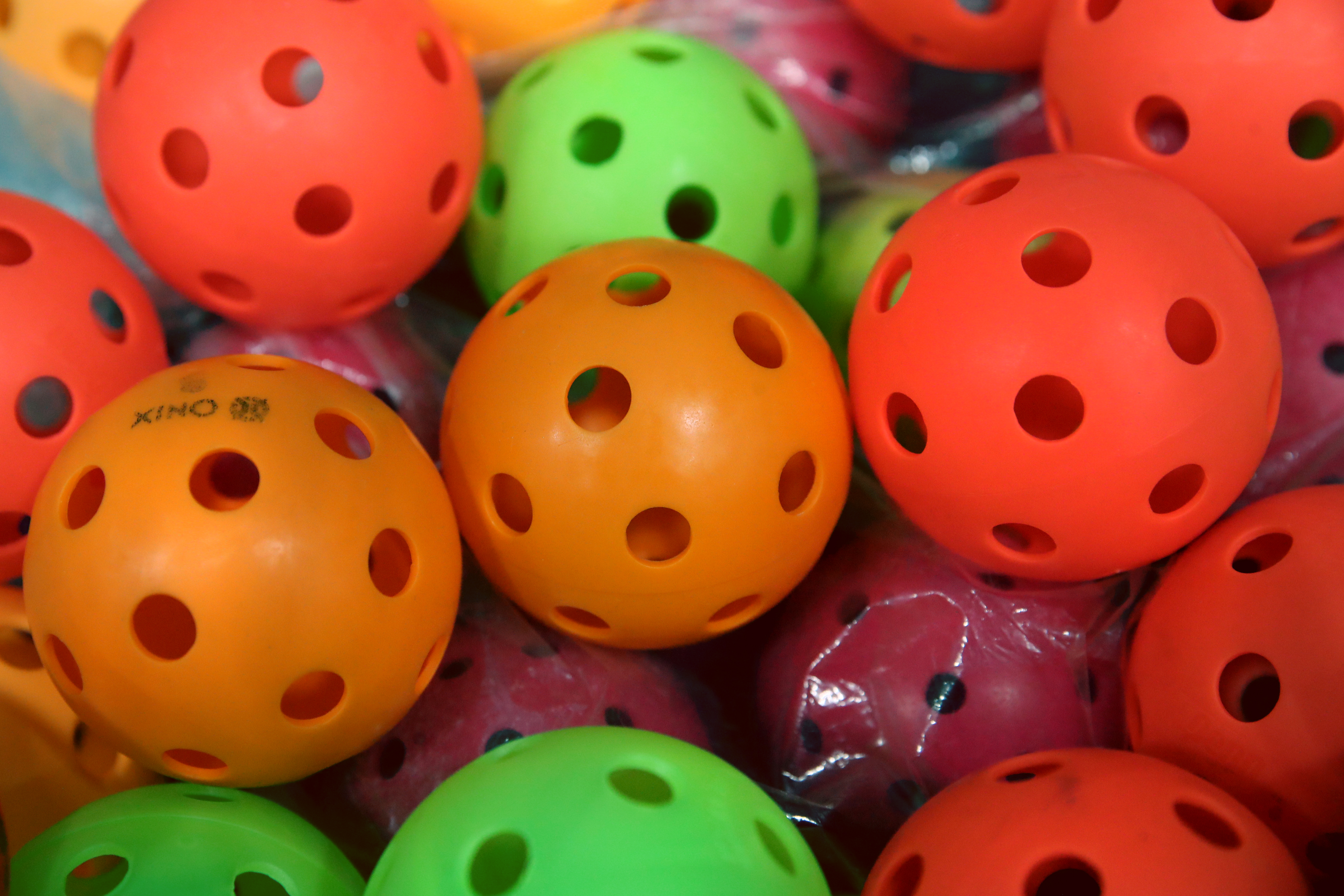 A collection of pickleballs.