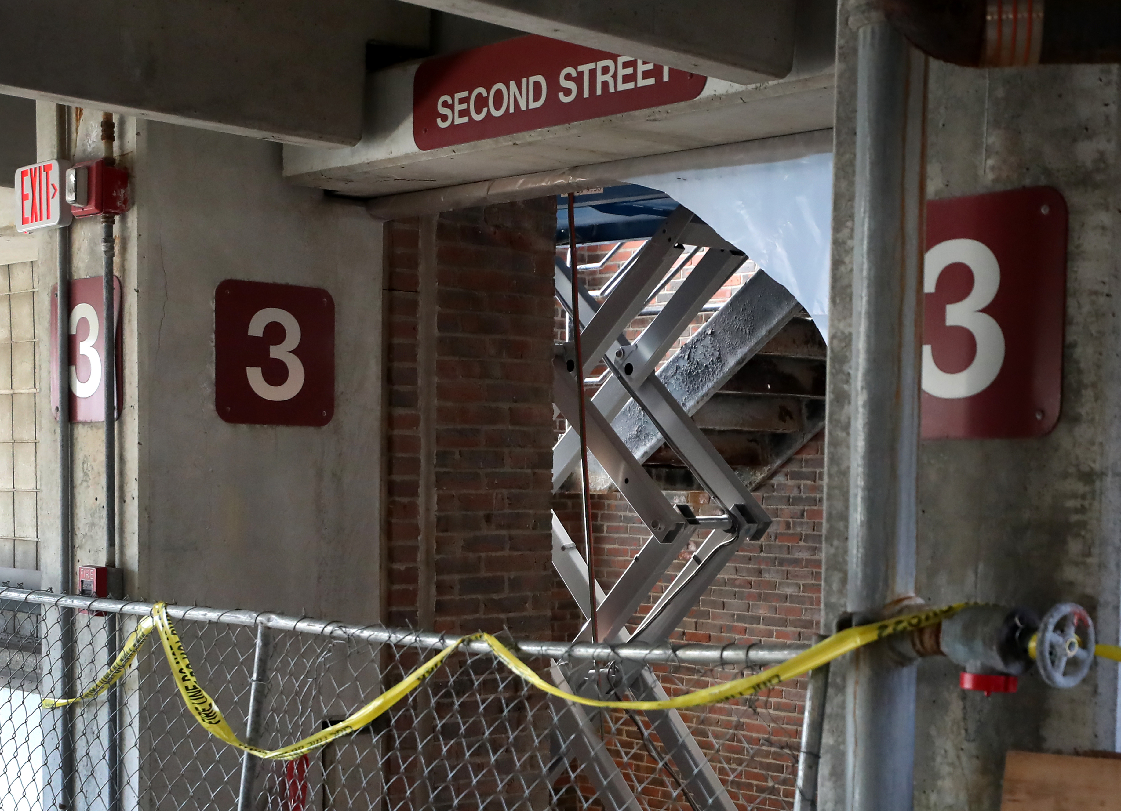 A section of the concrete stairwell under renovation collapsed at the city-owned First Street Garage in East Cambridge.