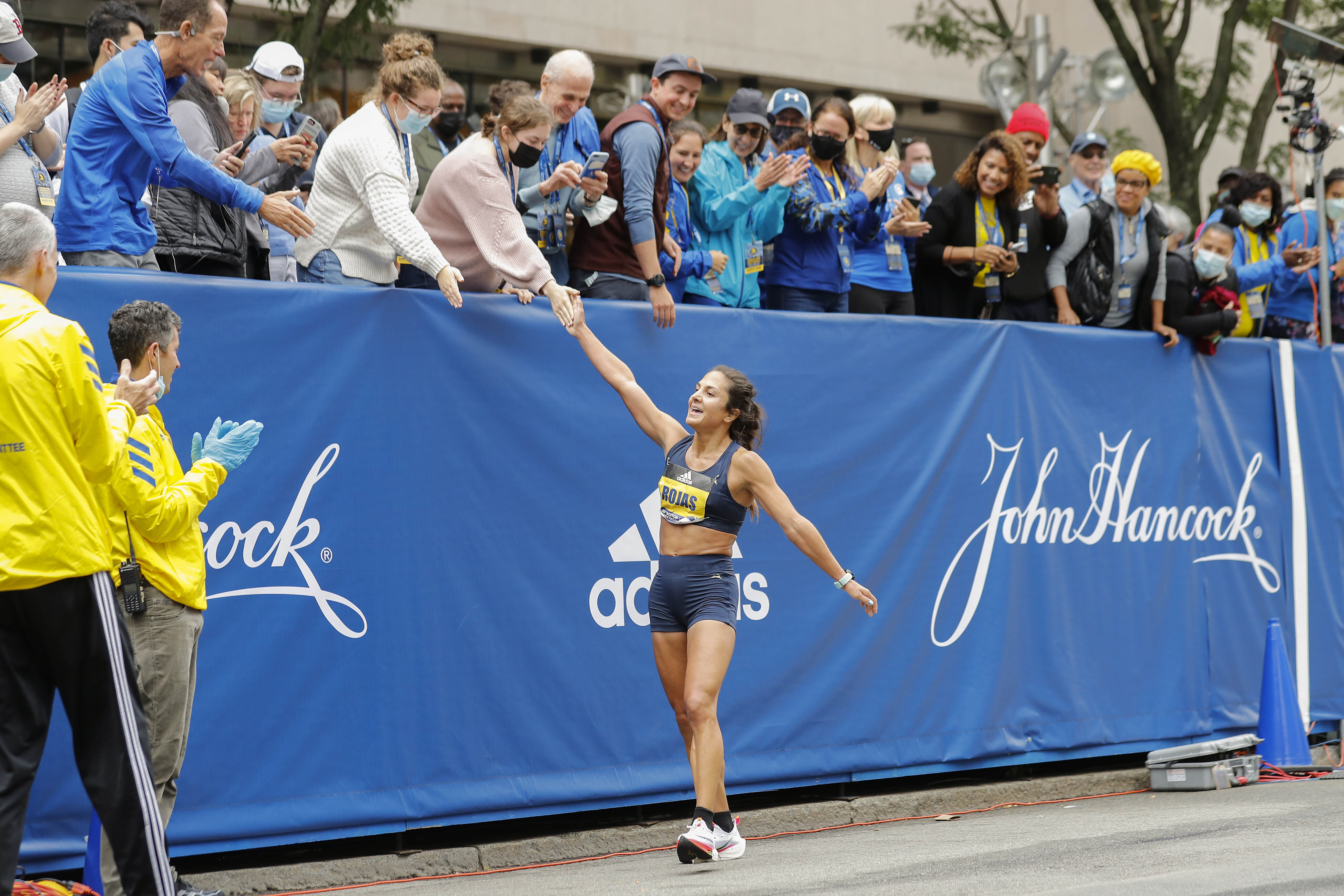 Nell Rojas is congratulated after crossing the finish line Monday.