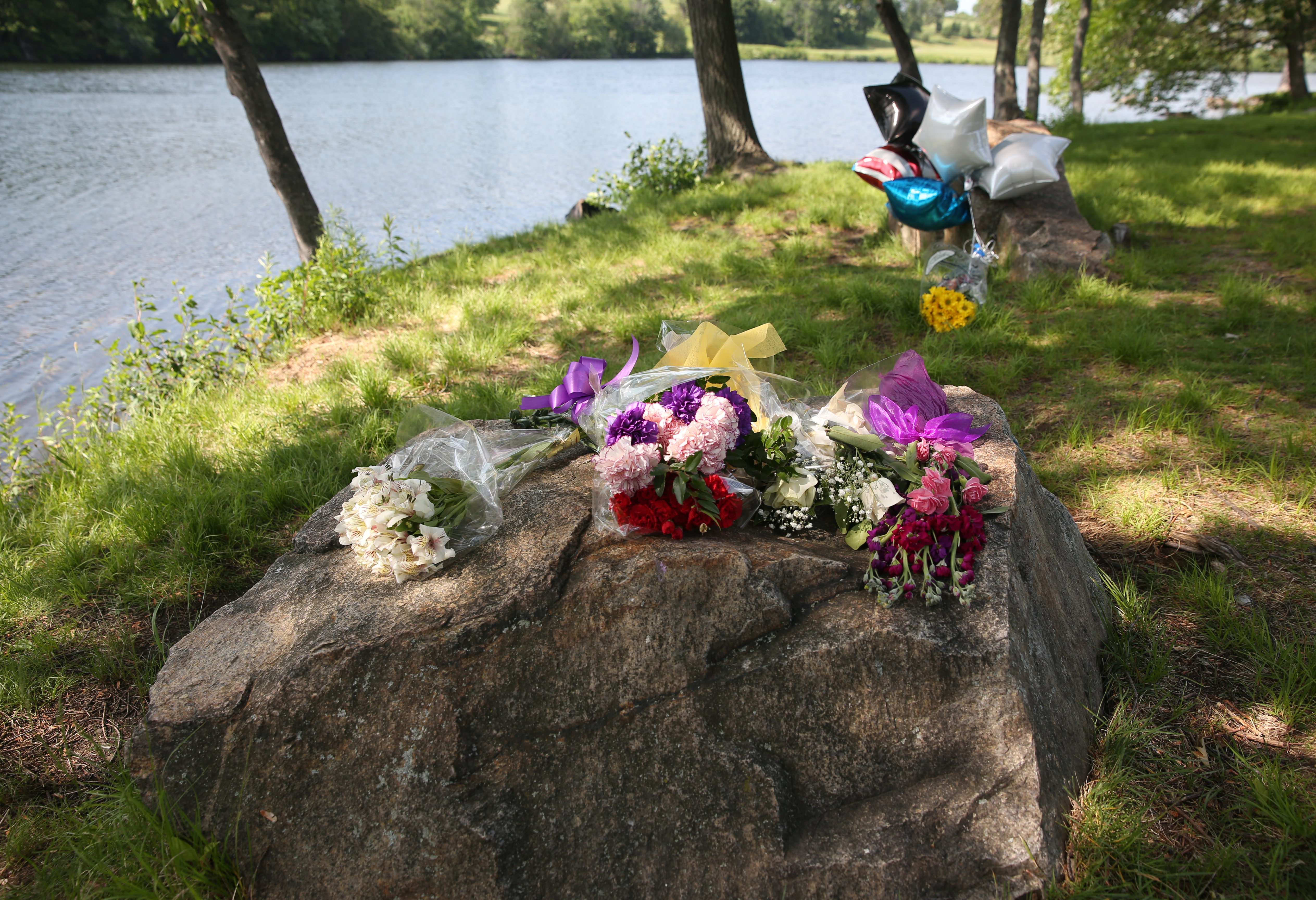 A makeshift memorial at Green Hill Park where Worcester police officer Enmanuel Familia drowned when attempting a rescue of teenager Troy Love, who also drowned.