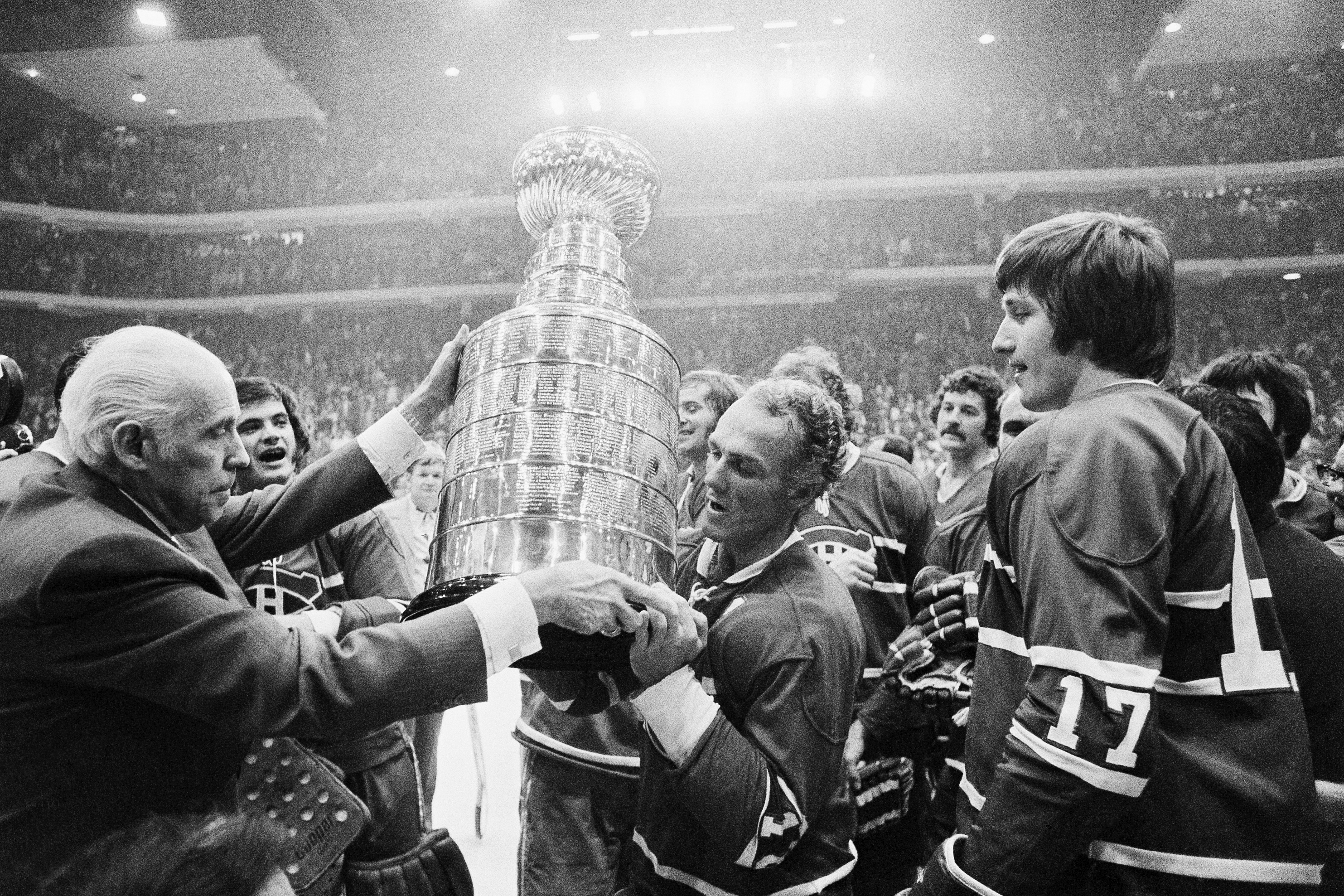 Henri Richard (center) receives the Stanley Cup from NHL president Clarence Campbell (left) in 1973.