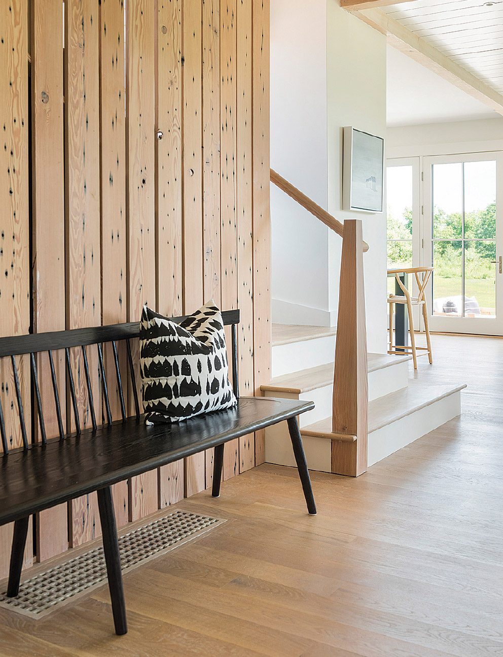 Furniture studio O&G in Warren, Rhode Island, made the 7-foot-long bench in the entry.