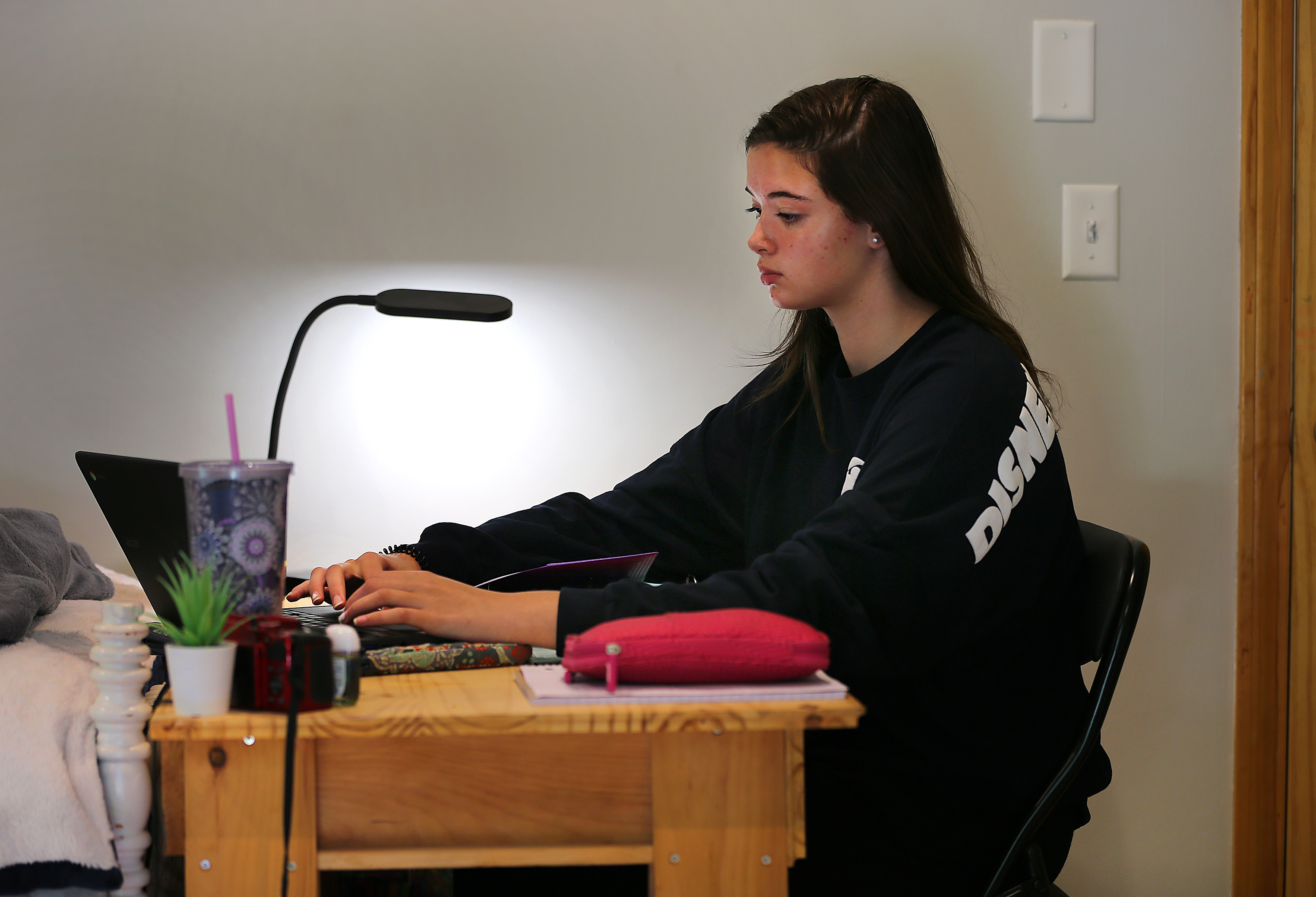 Amelia Cody, an 8th-grader, studied remotely in her bedroom.