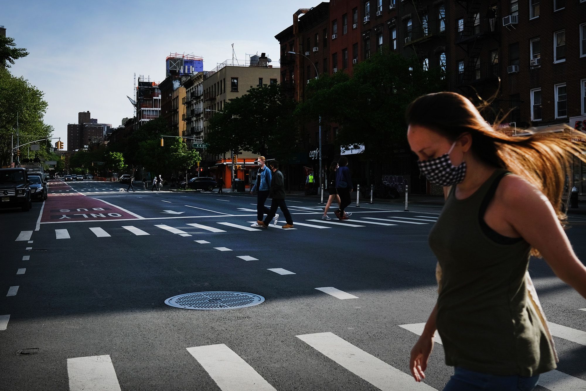 Pedestrians cross a street in lower Manhattan on May 19.
