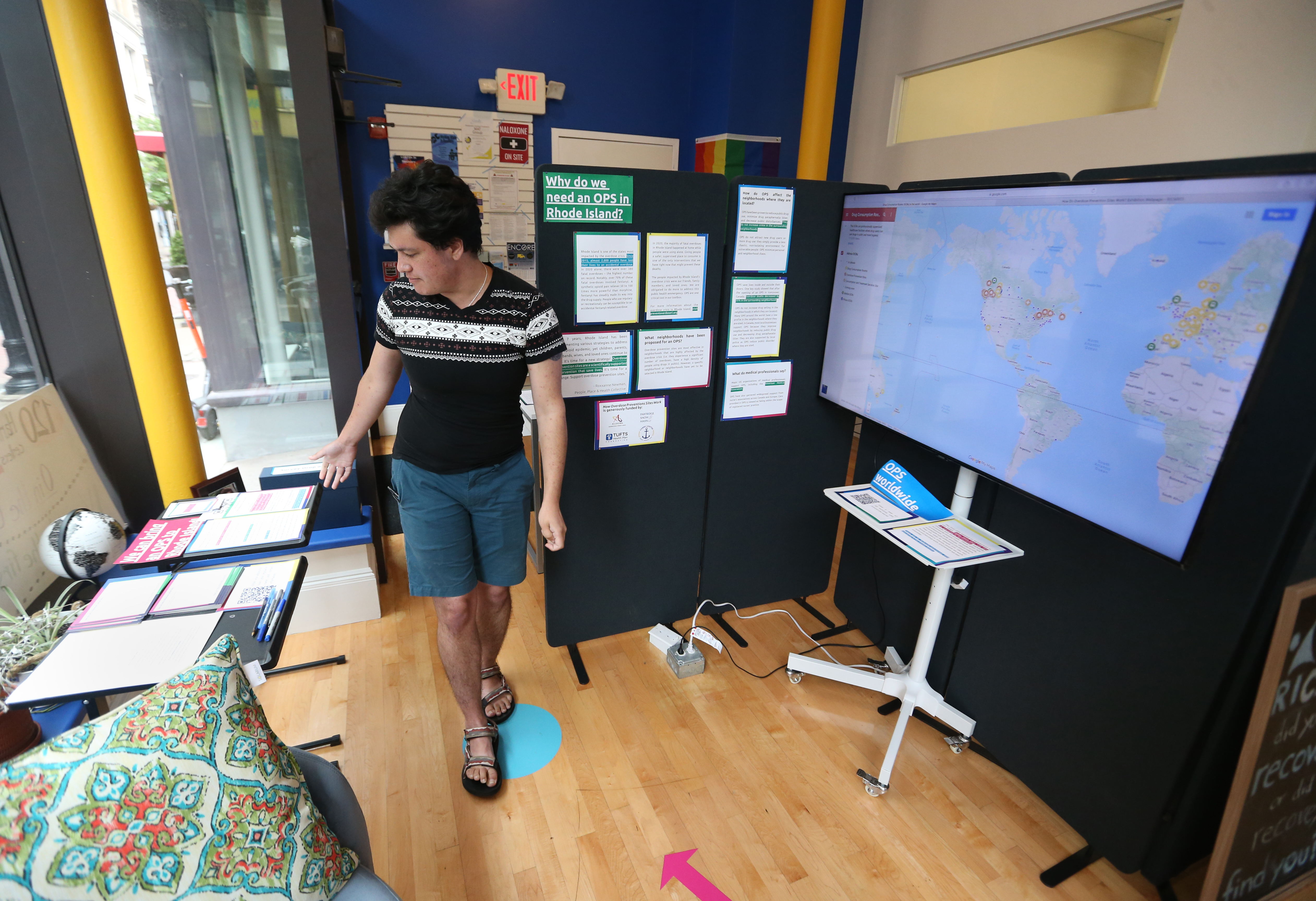 Selene Means, visual designer for the group RICARES, led a tour of the exhibition of an overdose prevention site in Providence.