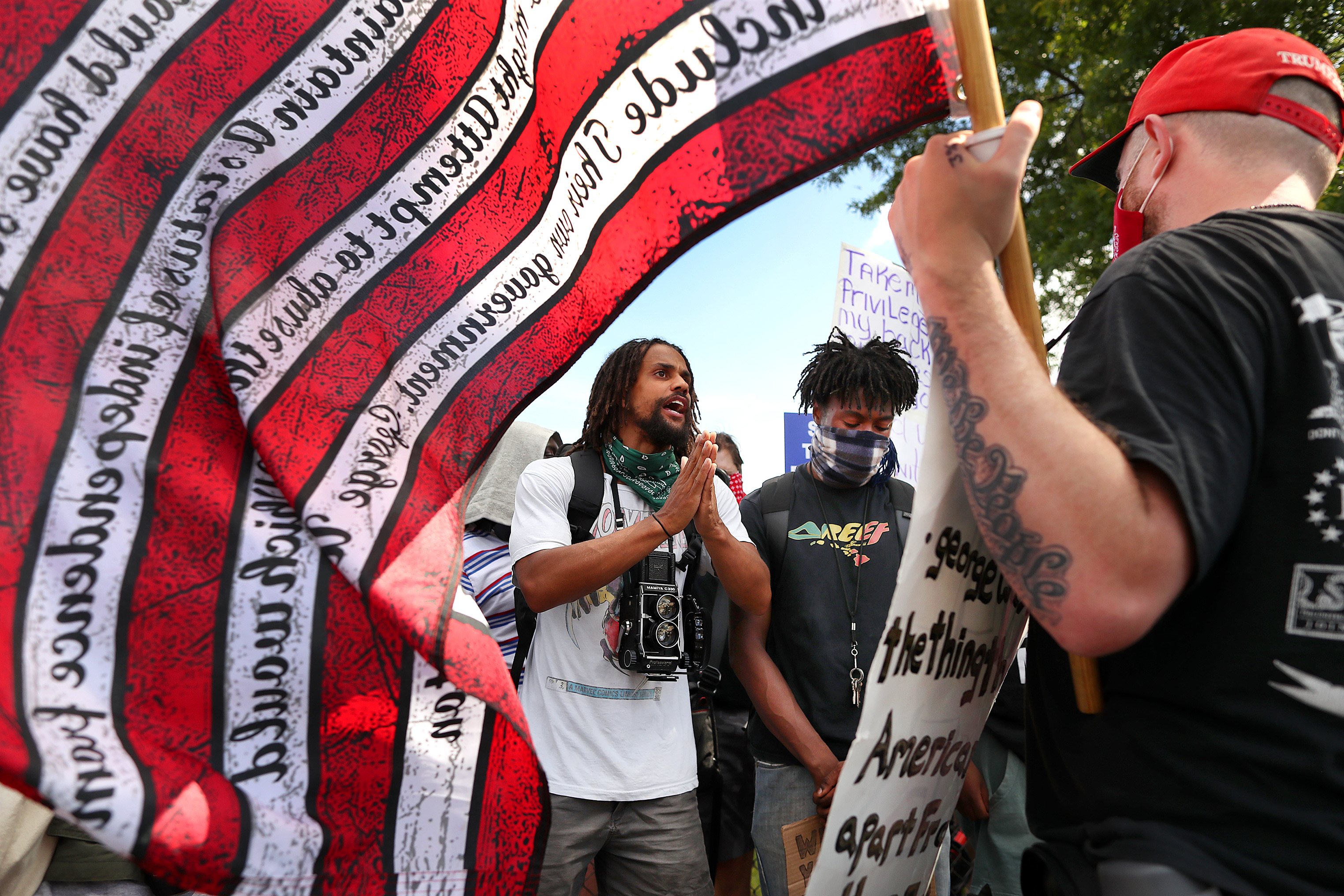 Photographer Sam Williams (center) had a passionate conversation with a counter-protester on the street near a Dorchester park on Juneteeth day.
