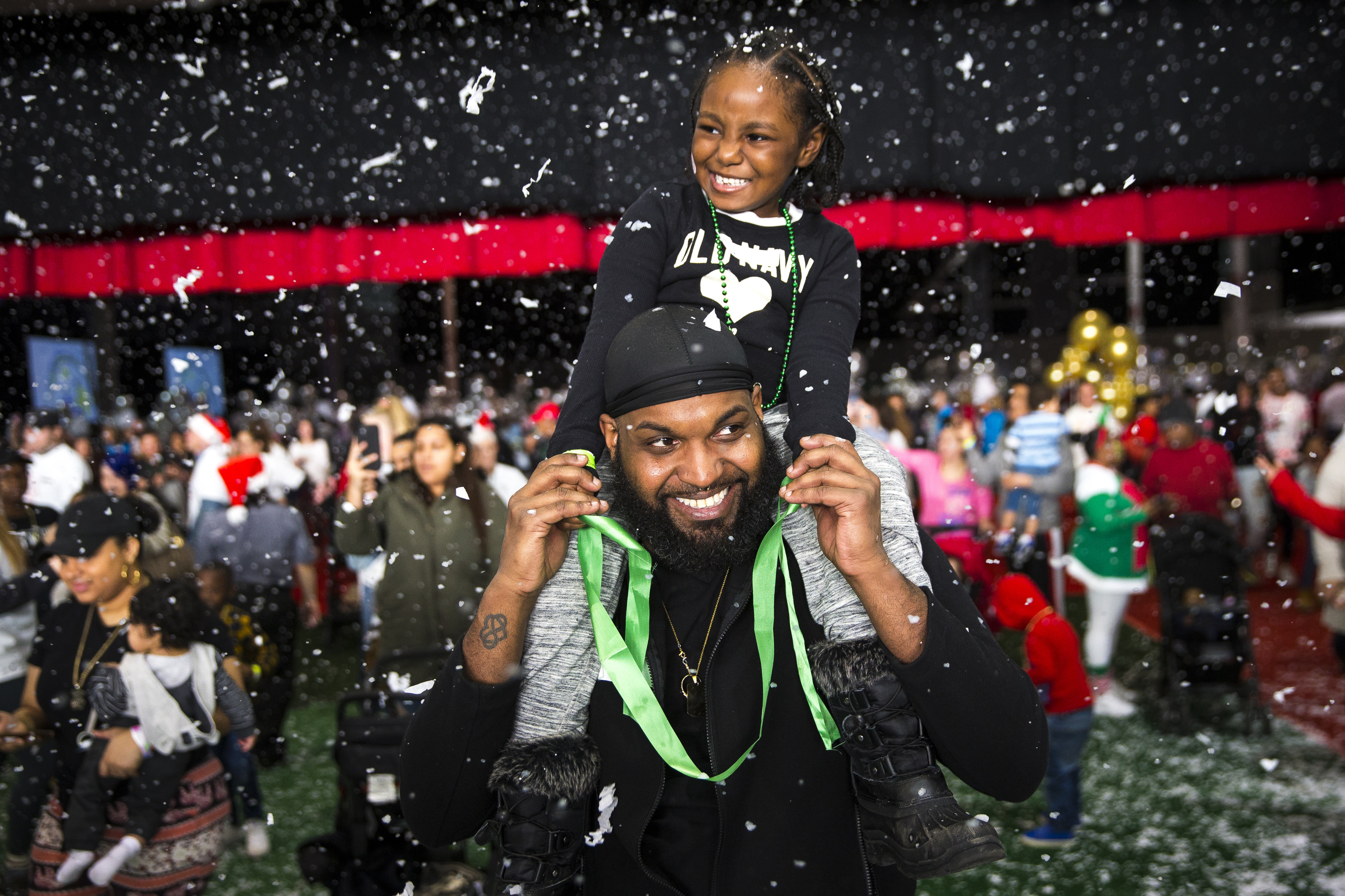 Dana Mendes held his niece, Izariel Brown, age 5, as they walked into the Winter Wonderland at the annual Christmas in the City event at the Boston Convention and Exhibition Center on Dec. 22.