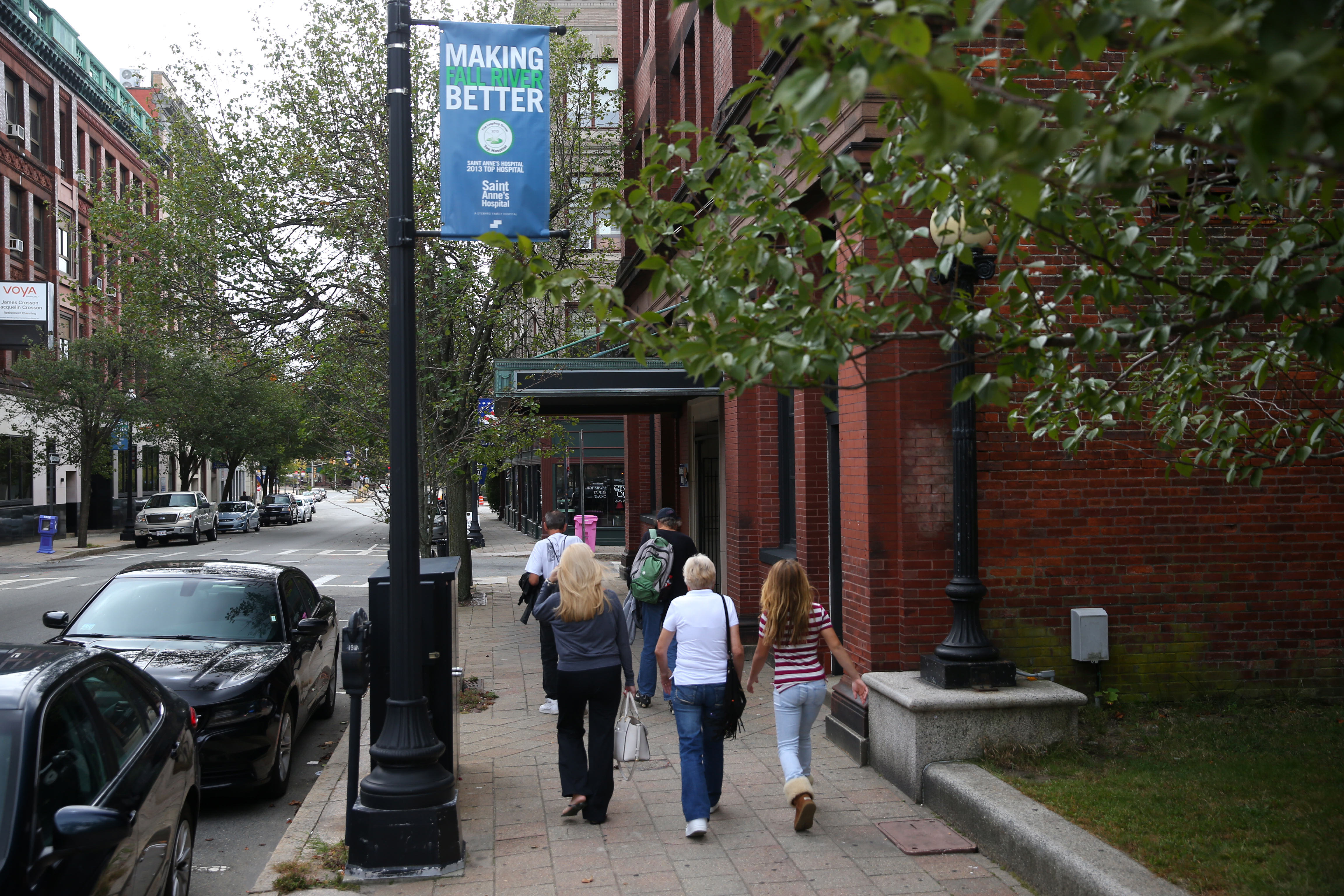 Pedestrians strolled in Fall River’s downtown. Not far away, an old mill complex is now home to PrimaCARE, a multispecialty medical group.