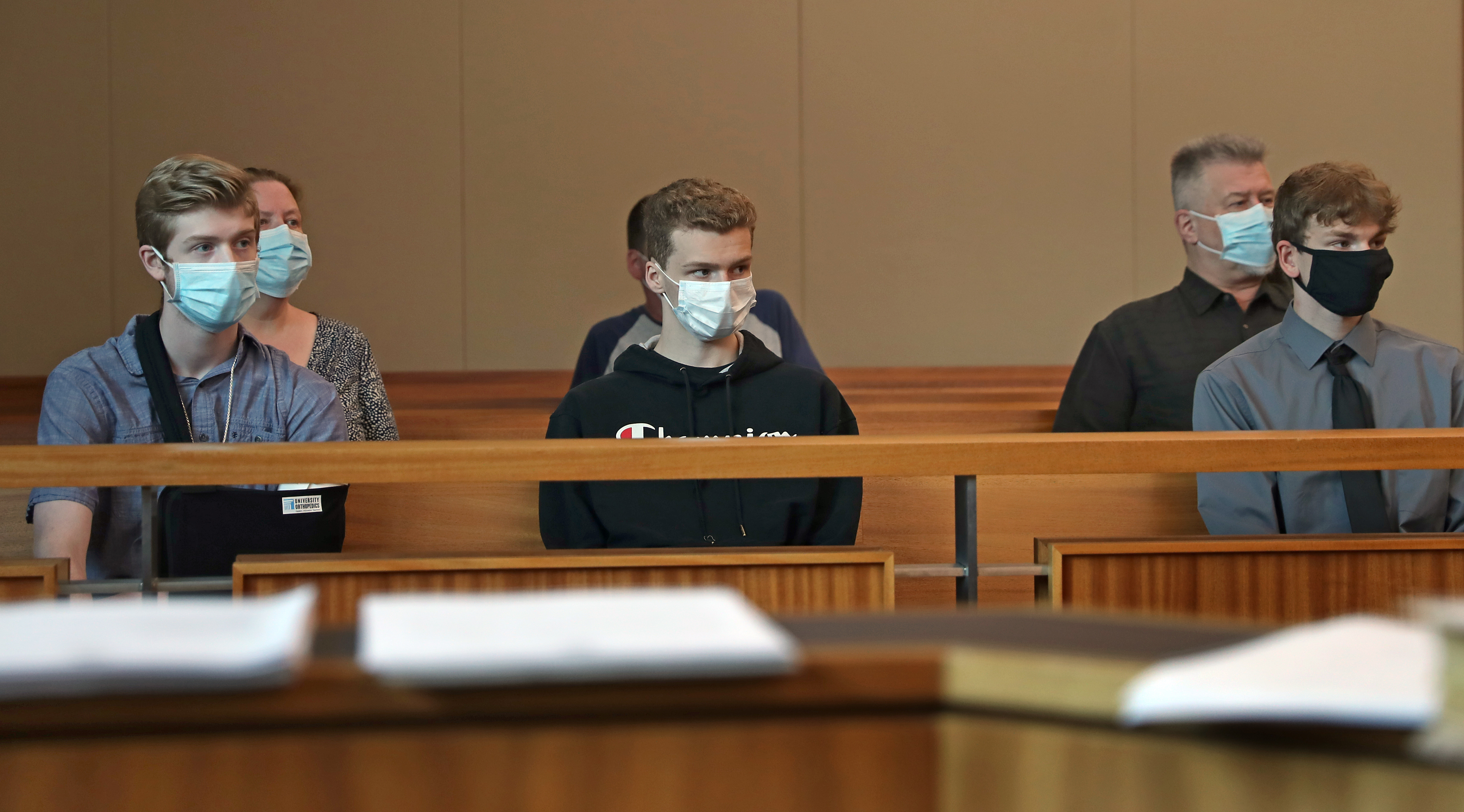 Victims seated in courtroom are Dominic Vincent (far left in arm sling) with brothers Vincent Greco and Joseph Greco and other family members.