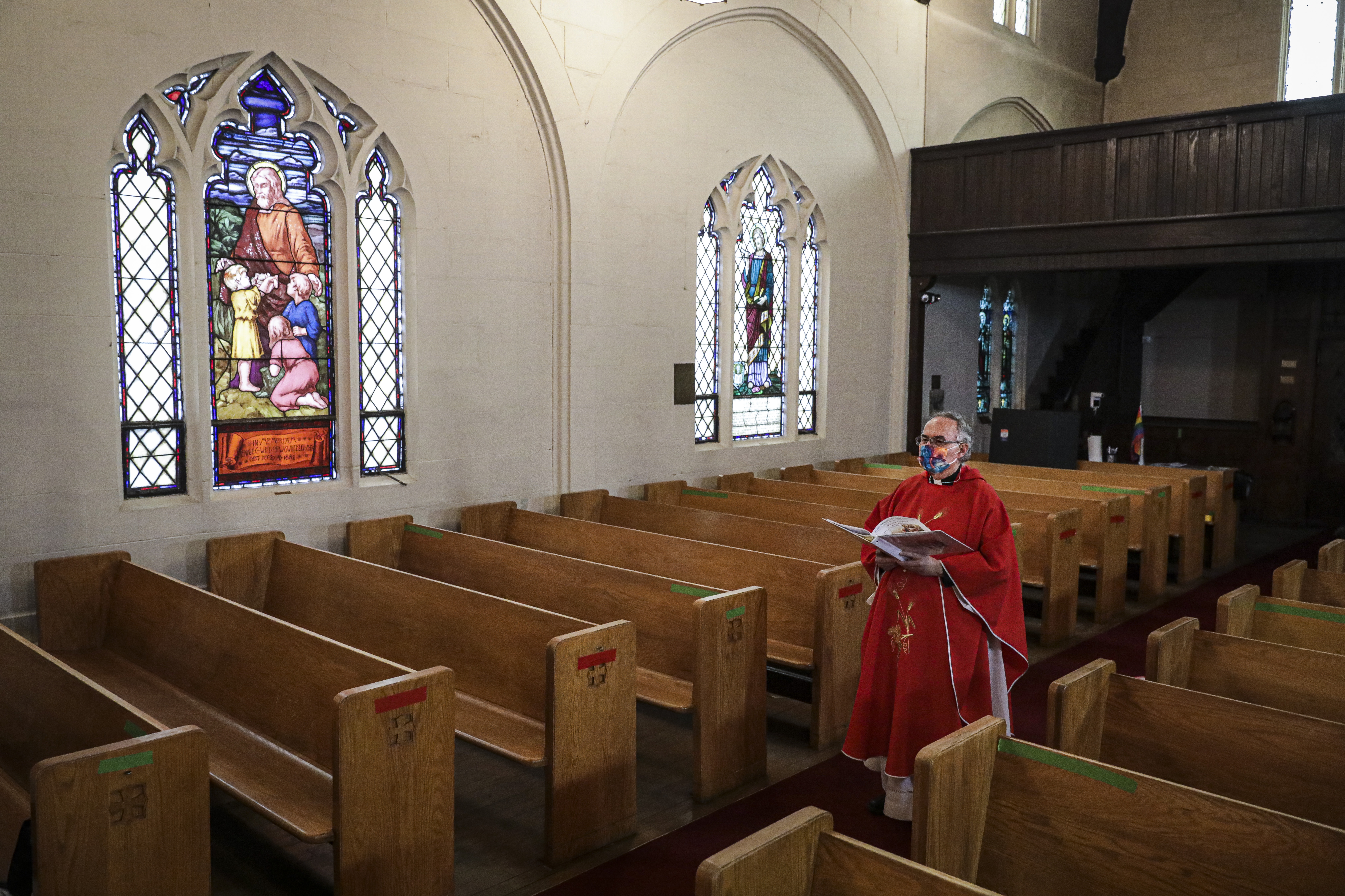 The Rev. Edgar Gutierrez-Duarte of St. Luke-San Lucas in Chelsea waited in the aisle before beginning a service on Thursday. At St. Luke-San Lucas, the bilingual service was virtual and offered to the congregation live on Facebook.