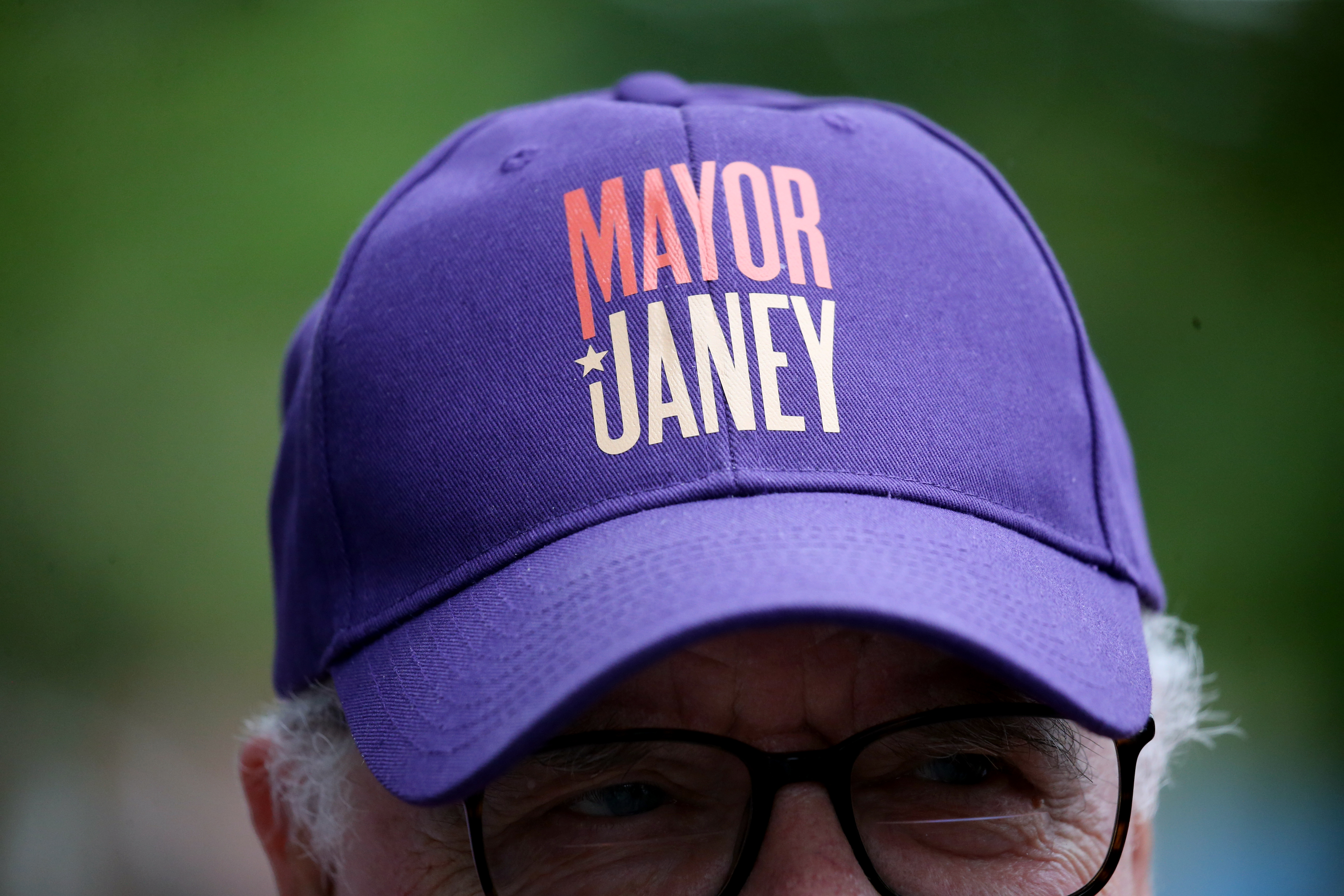 A man wears a hat supporting Acting Mayor Kim Janey during her campaign office opening Saturday in the Jamaica Plain.