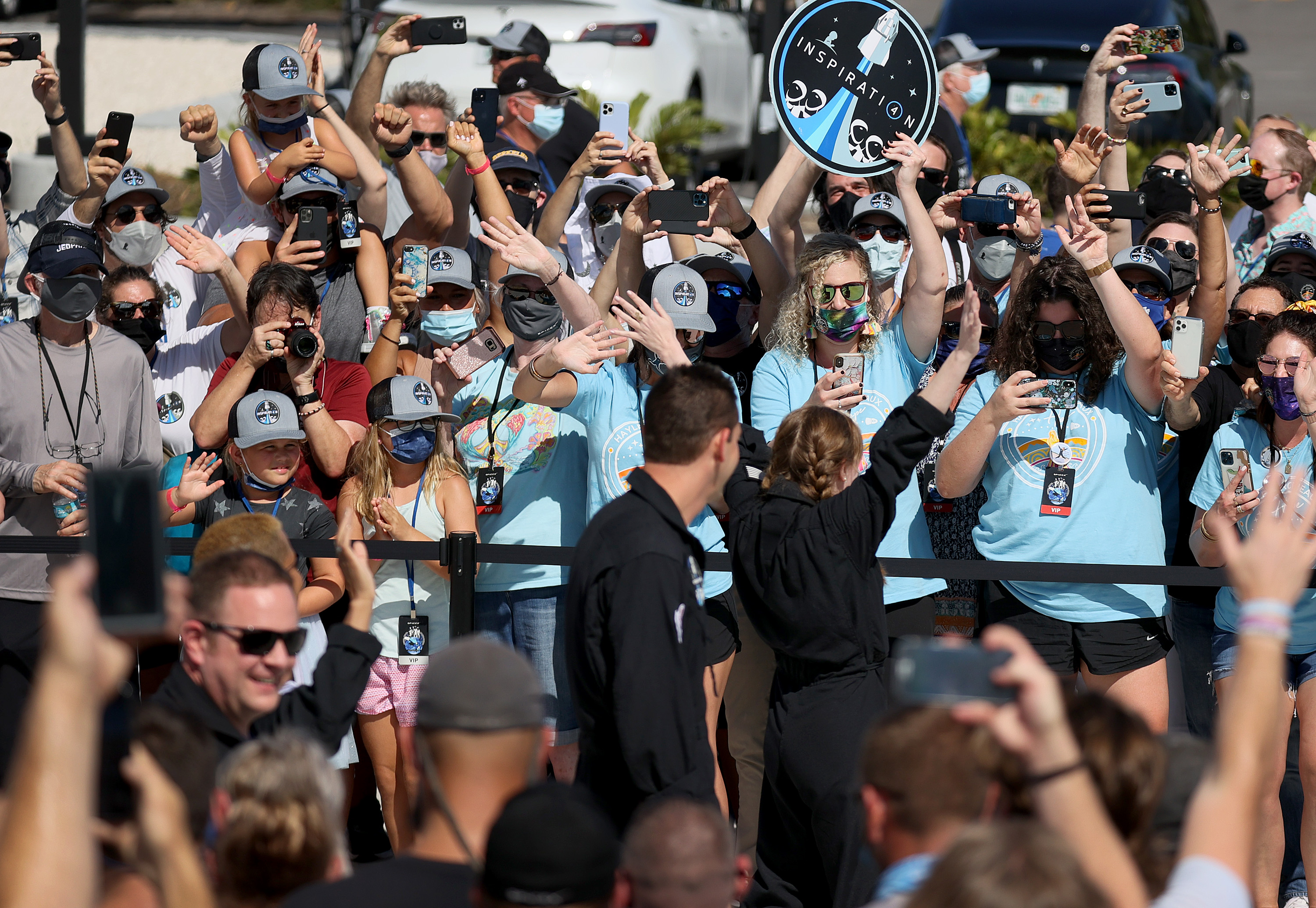 People watched as Inspiration4 crew members Jared Isaacman (center), Chris Sembroski, Hayley Arceneaux, and Sian Proctor prepared to leave for their flight on the SpaceX Falcon 9 rocket.
