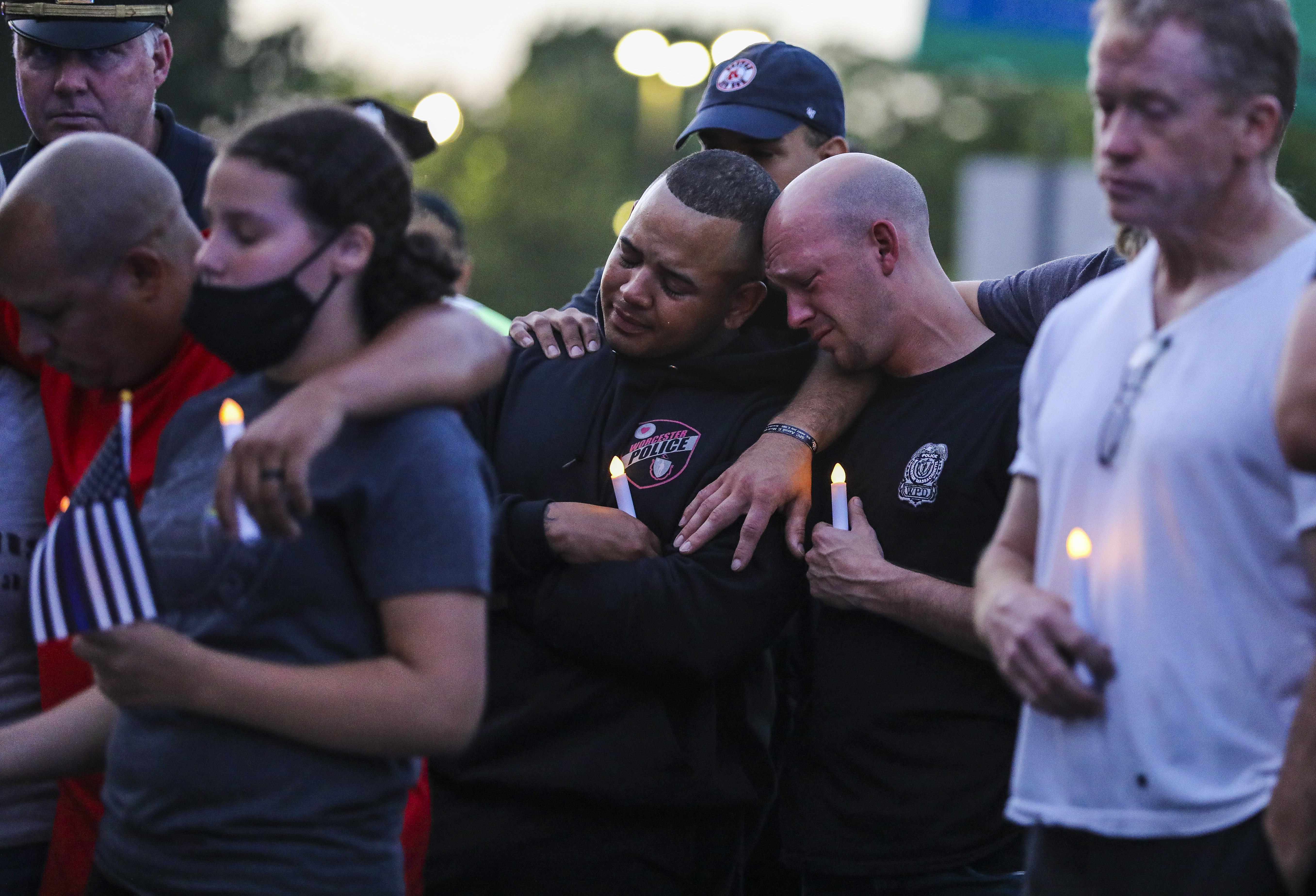 Members of the Worcester Police Department attended a vigil outside of St. Vincent Hospital to honor the officer who drowned attempting to save teens from Green Hill Pond.