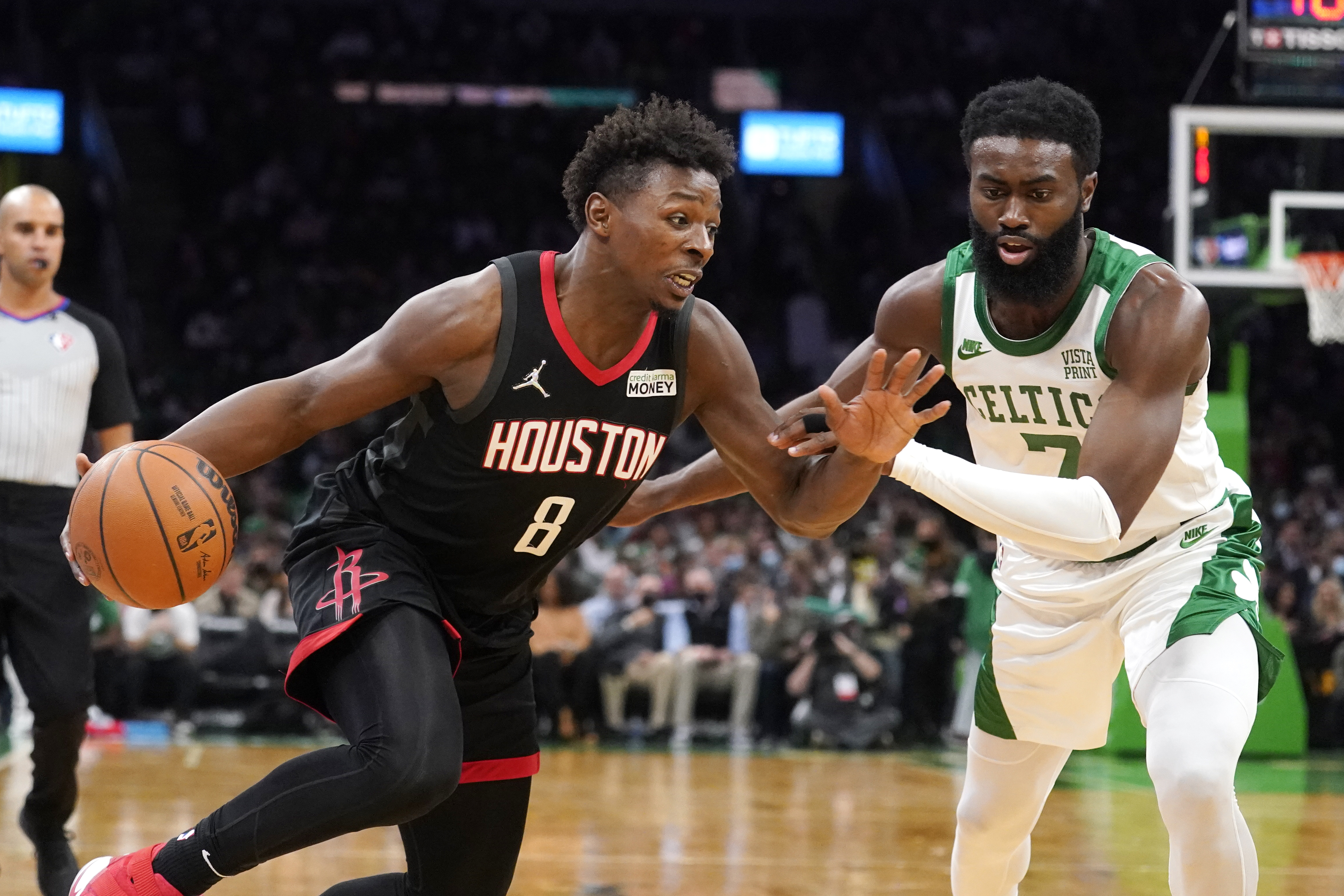 Houston's Jae'Sean Tate tries to drive past Jaylen Brown during the second half of Monday's game.