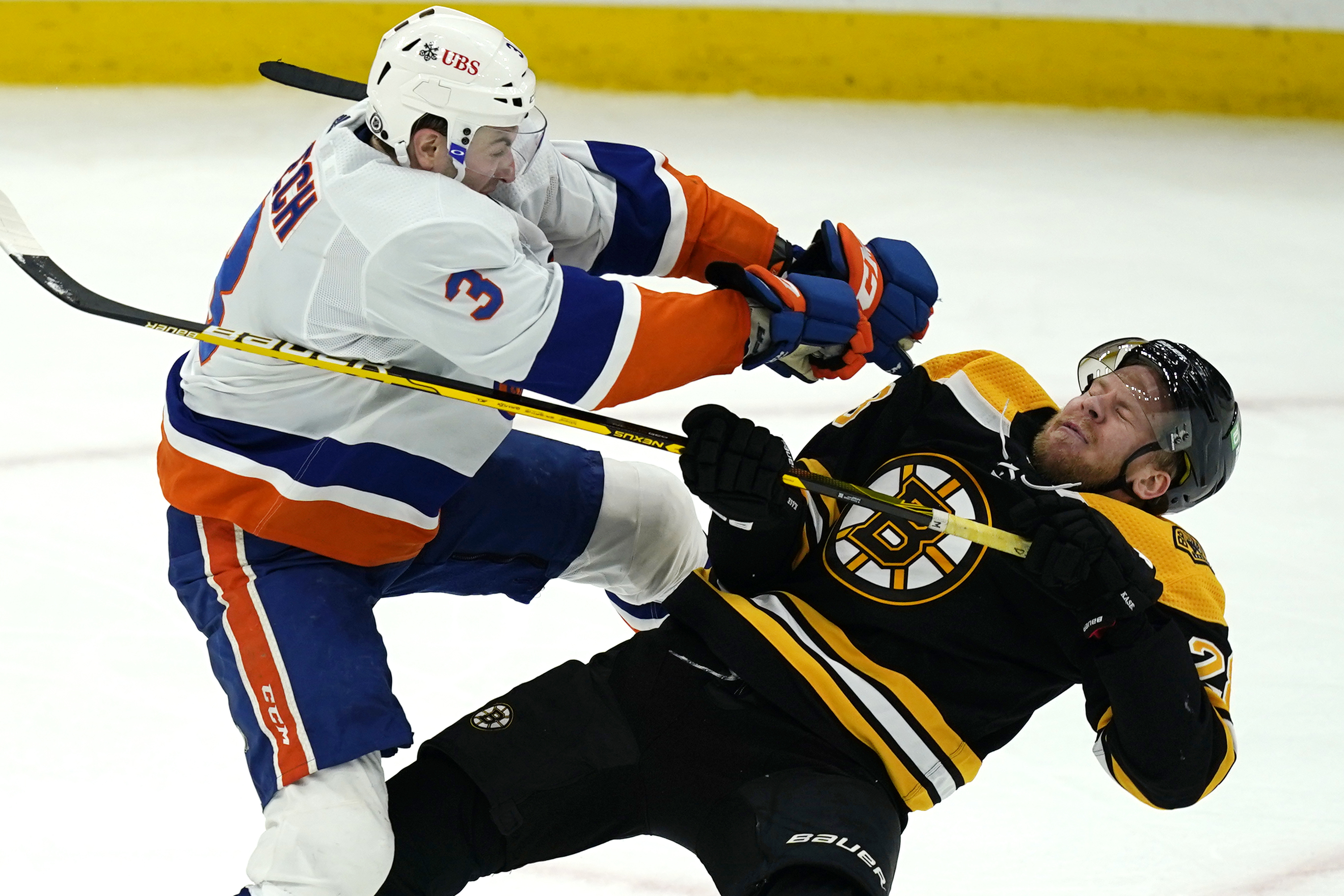 Ondrej Kase is leveled by New York's Adam Pelech in the second period of Monday's game.
