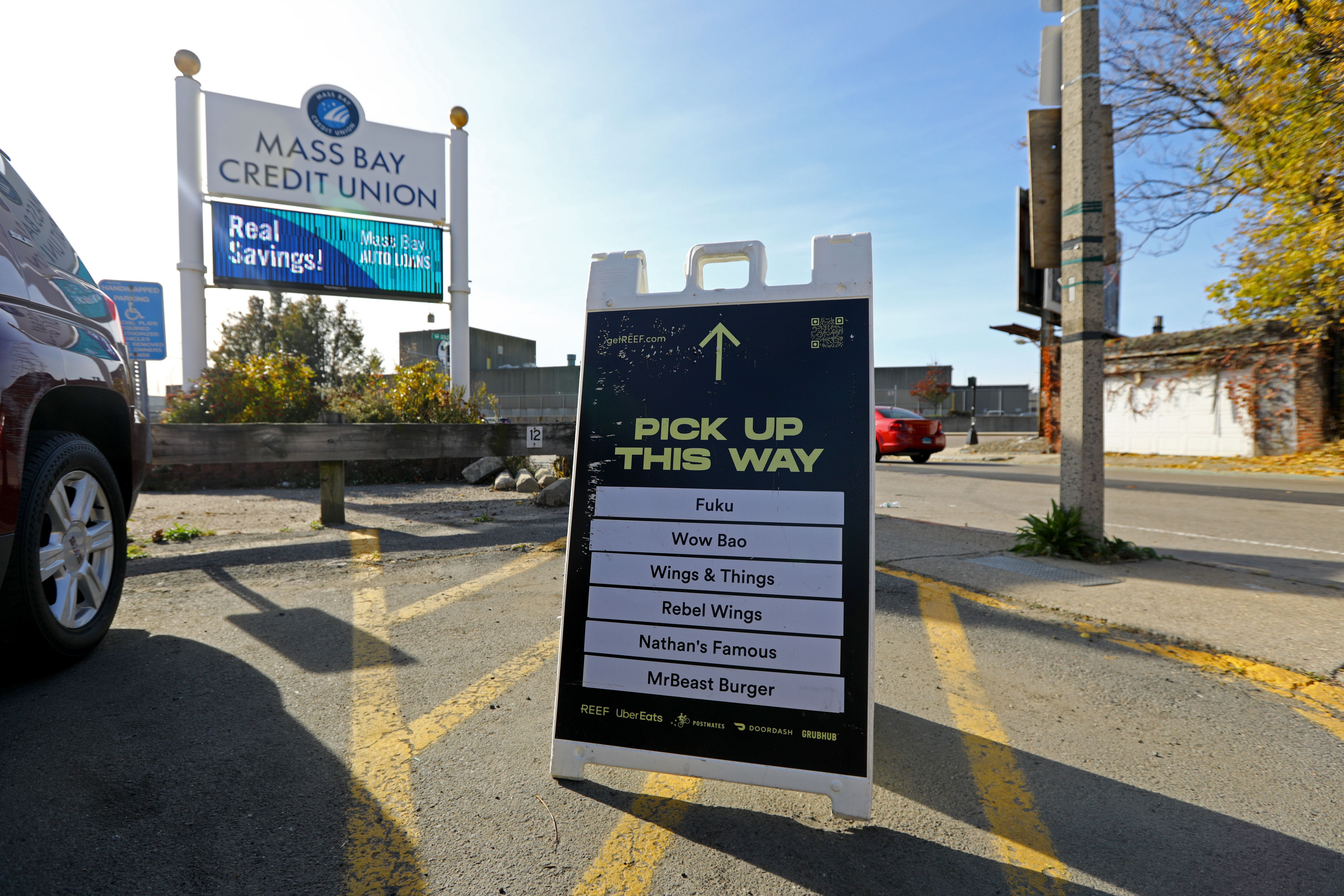 A “ghost kitchen” run by Reef Technology operated in a small parking lot on A Street in South Boston. The chefs create meals for several restaurants, including the ones on this sandwich board.  
