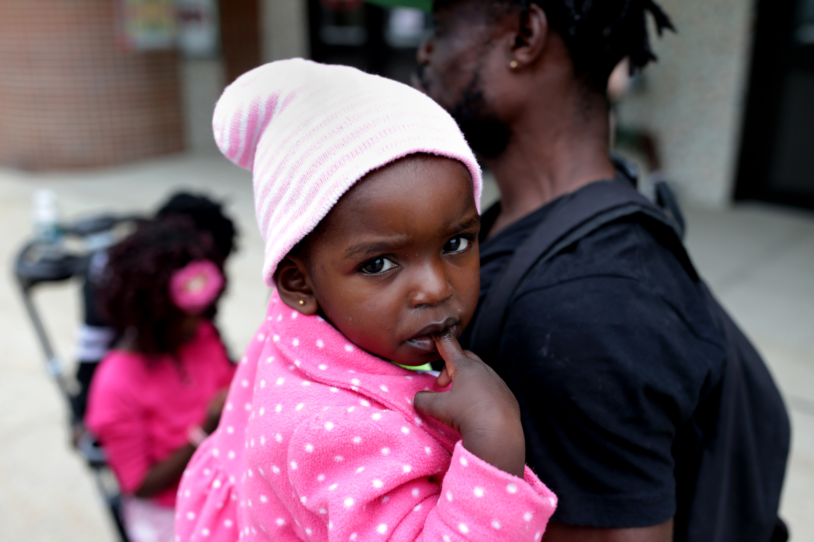 Jean Garcia Mabaka Yangu, a refugee from the Democratic Republic of the Congo, held his daughter, one of his four children. Portland’s EXPO Arena has been turned into a shelter for asylum seekers.