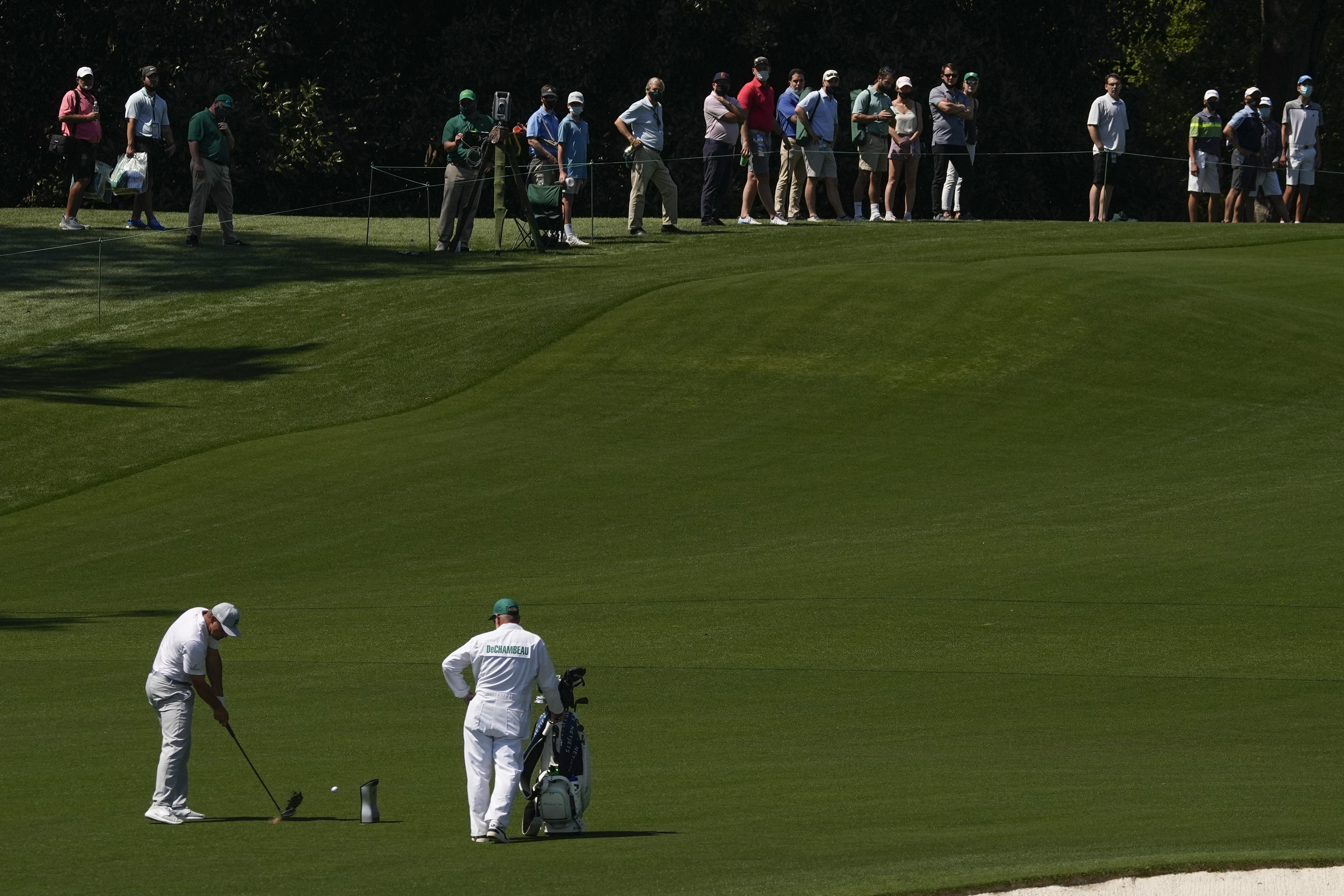 Bryson DeChambeau blasts one in front of fans during a practice round at Augusta.