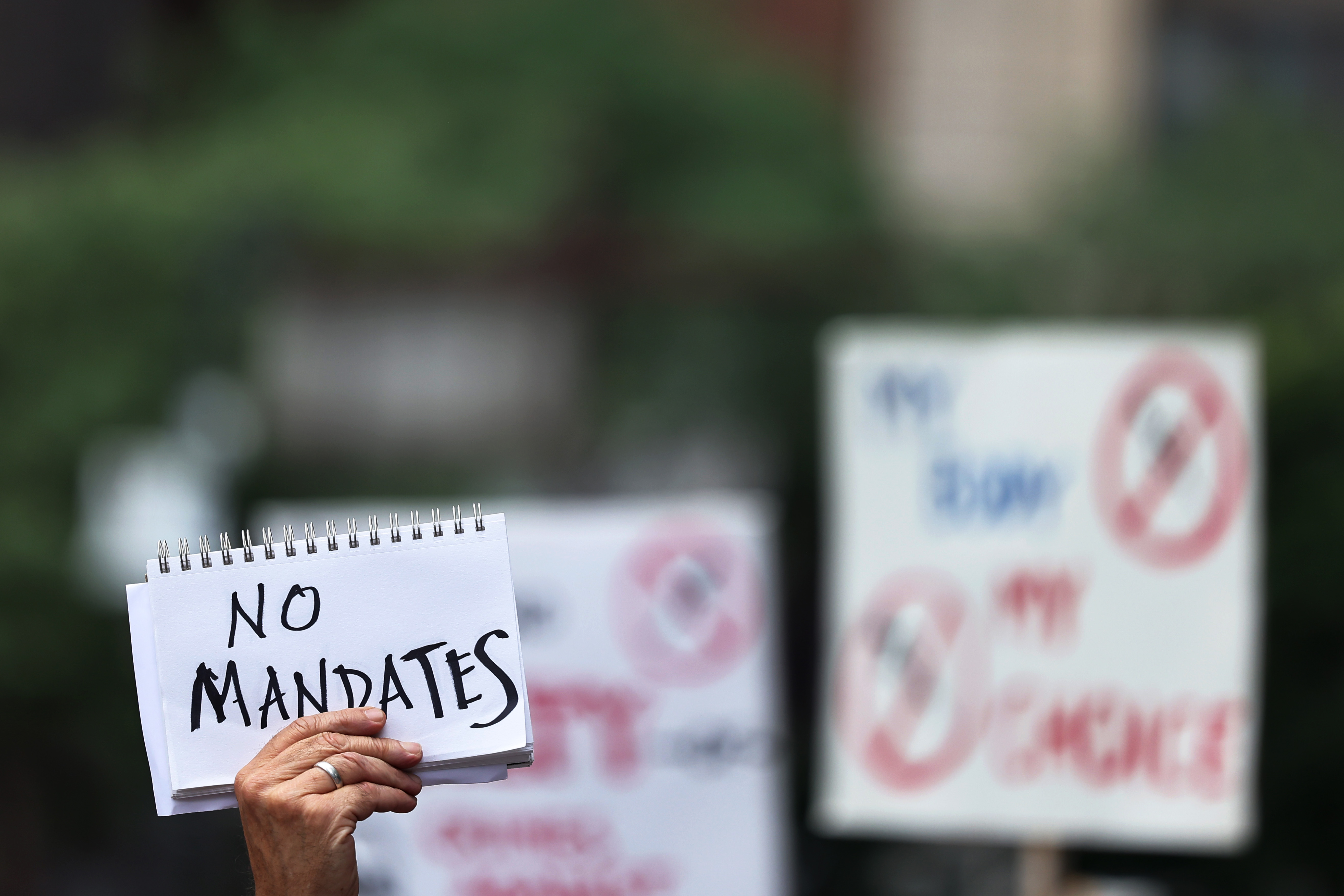 People gathered at City Hall to protest vaccine mandates on Monday in New York City.