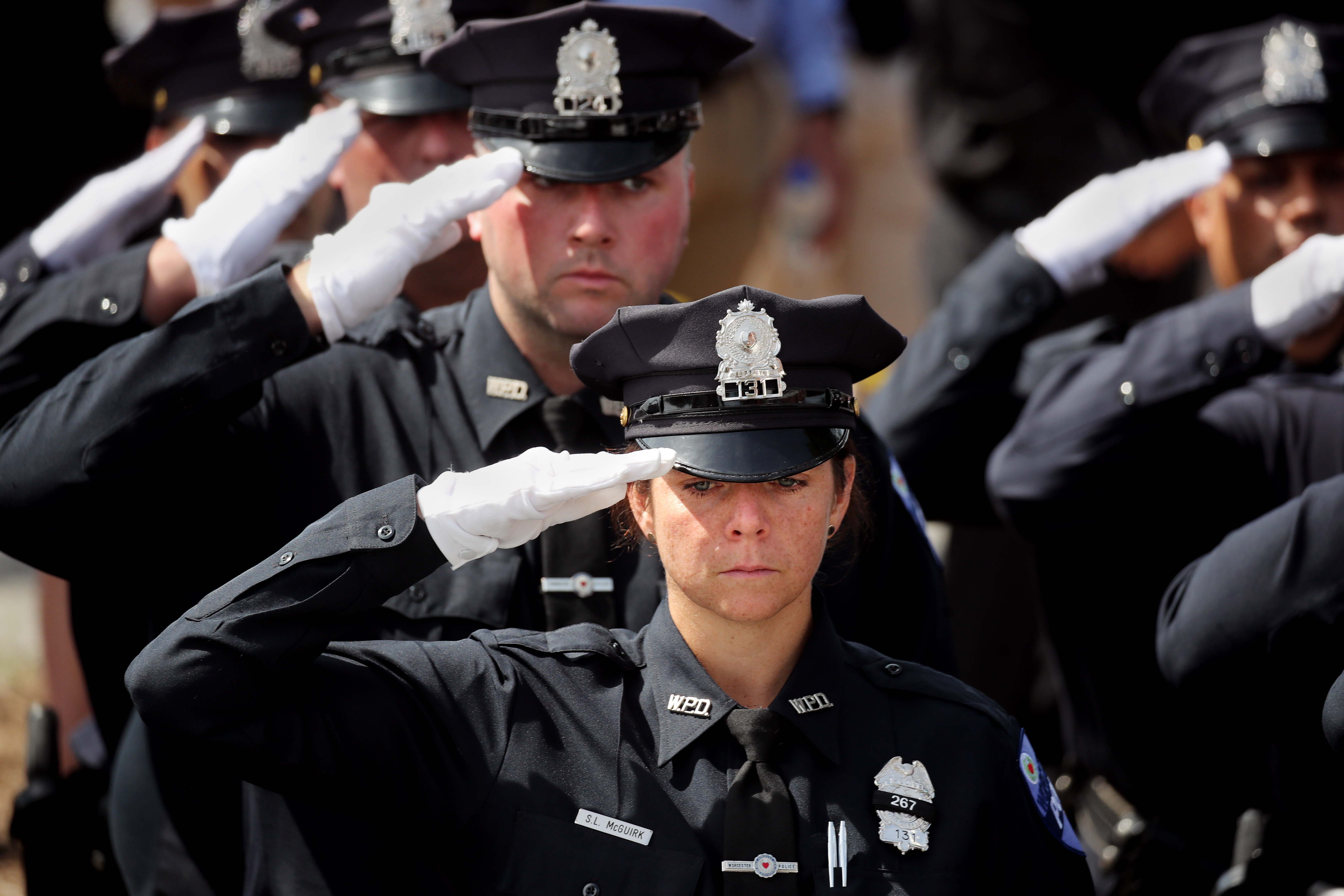 Worcester police officers saluted during a funeral service for Worcester Police Officer Enmanuel "Manny" Familia.