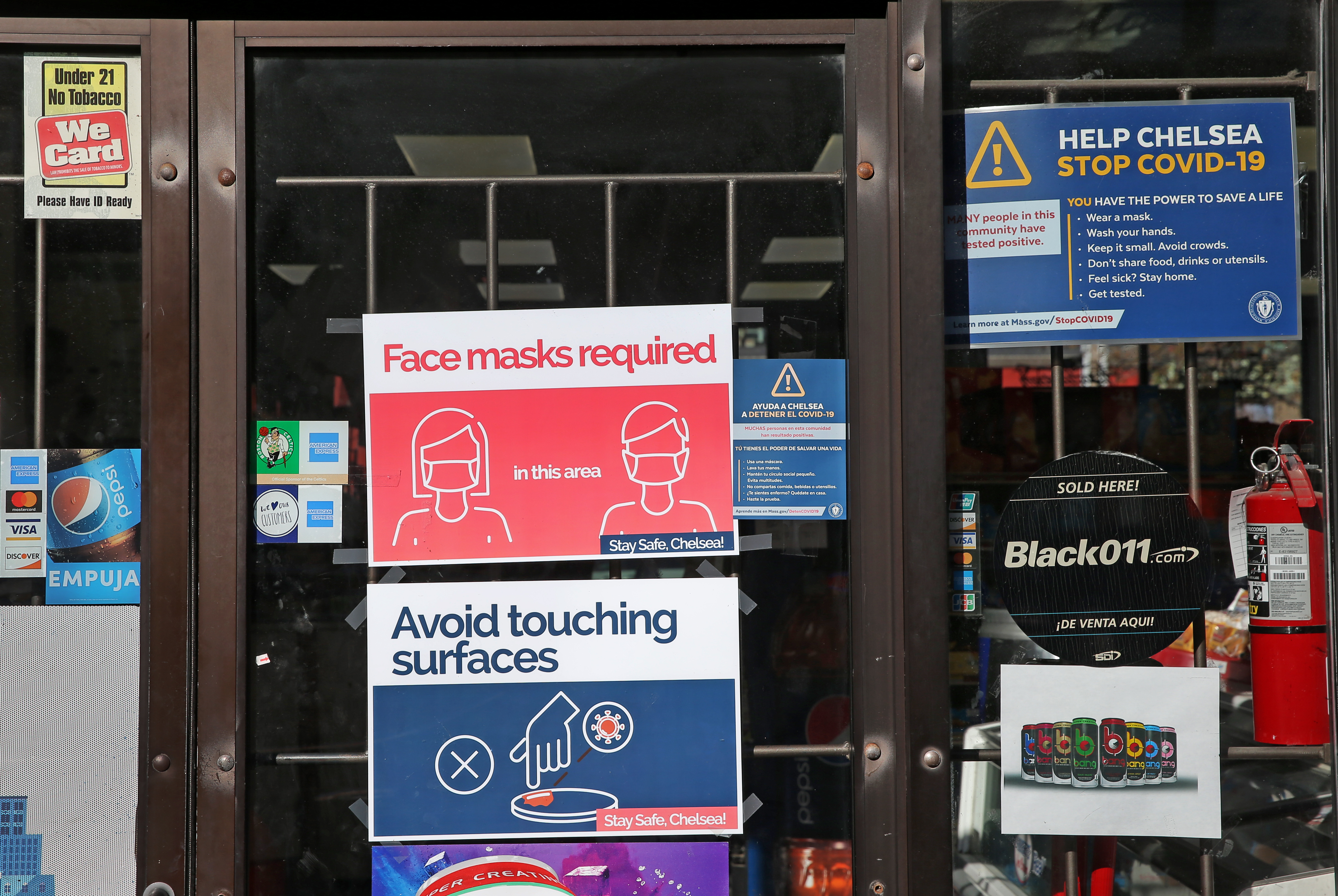 Signs about wearing masks and protecting neighbors are everywhere in Chelsea, such as at this storefront on Broadway.
