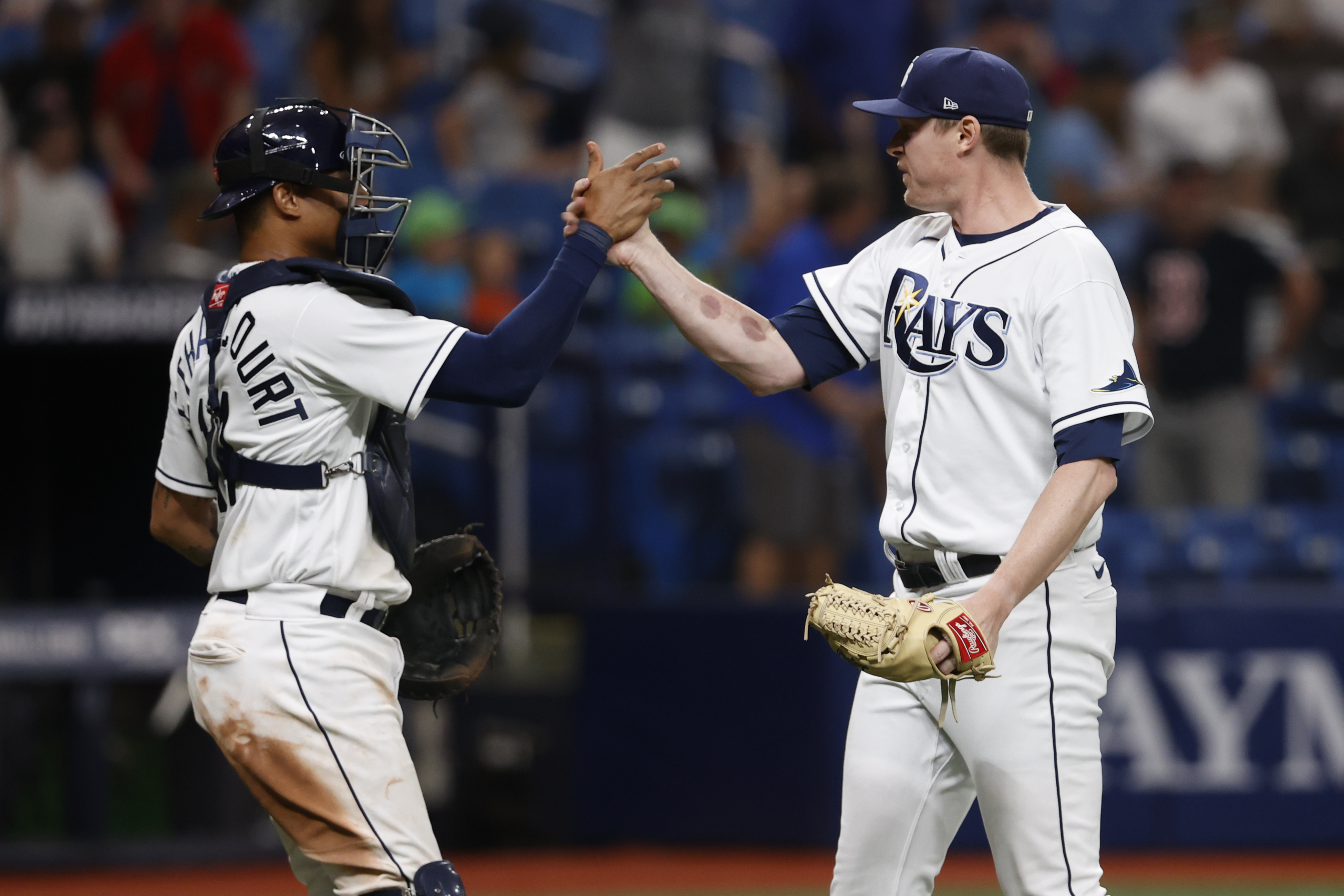 Tampa Bay Rays catcher Christian Bethancourt, right, leans away as