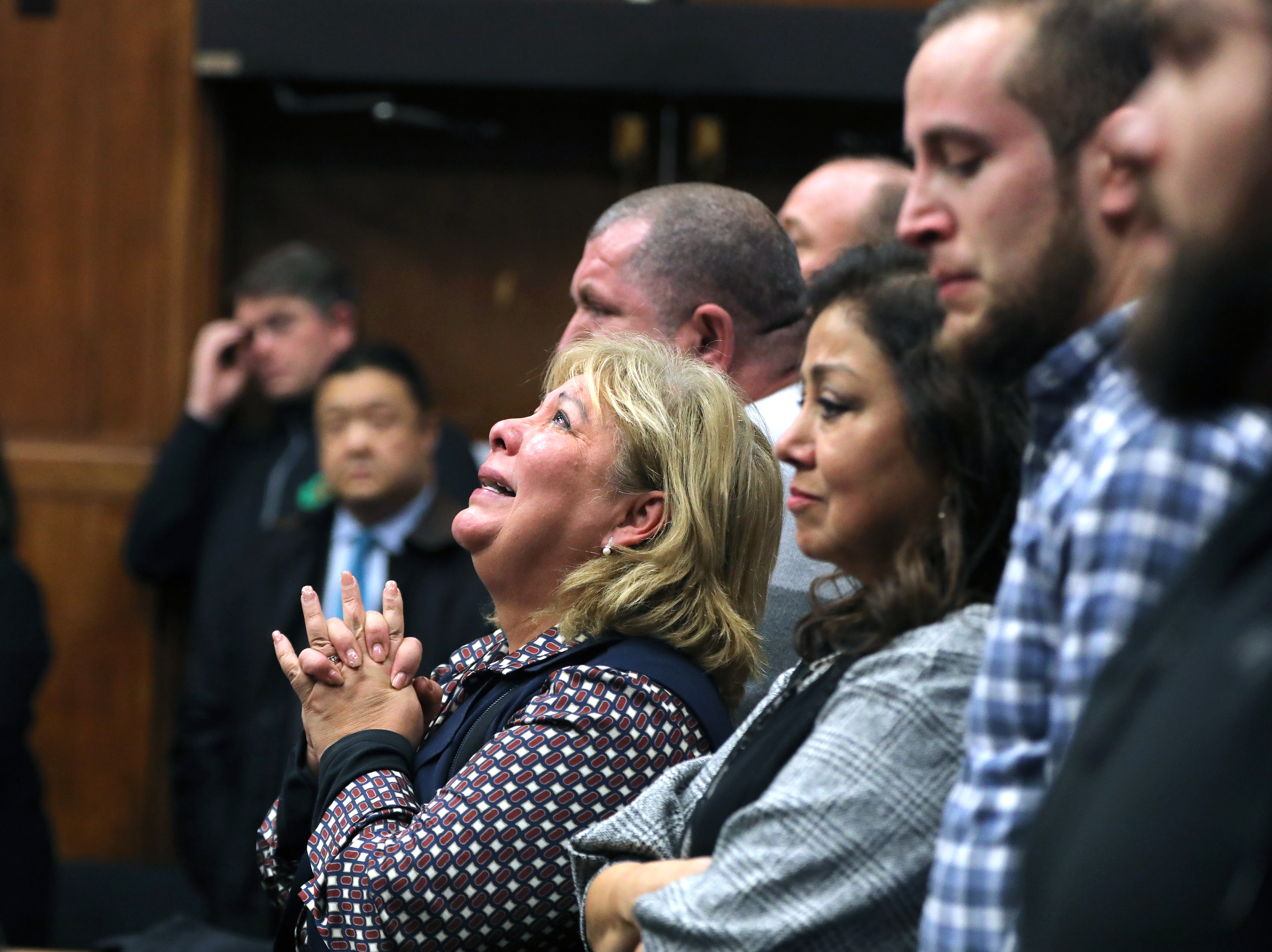 Ana Vergara, mother of Dr. Lina Bolanos, clasped her hands together in a Suffolk Superior Courtroom after Bampumim Teixeira was found guilty of murdering Bolanos and Dr. Richard Field.