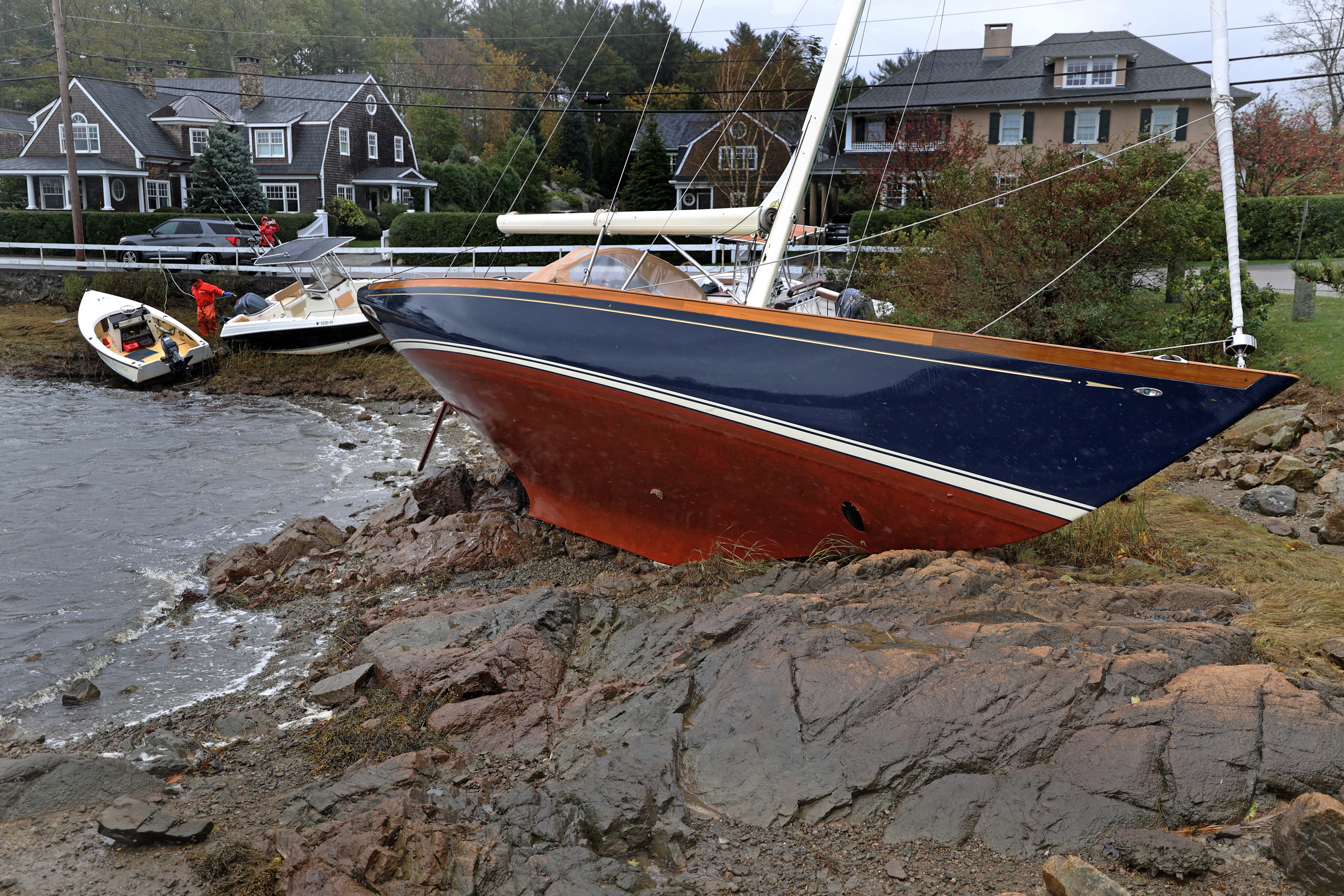Boats washed up on the rocks in Cohasset Harbor.