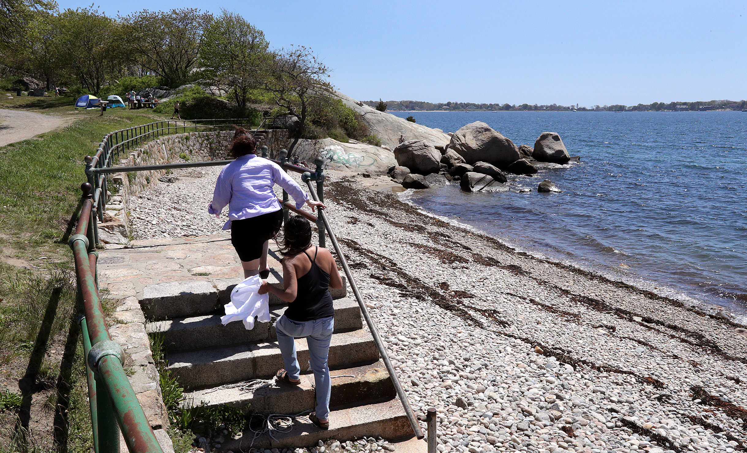 Visitors climbed the steps on the seawall at Cressy's Beach at Stage Fort Park in Gloucester.