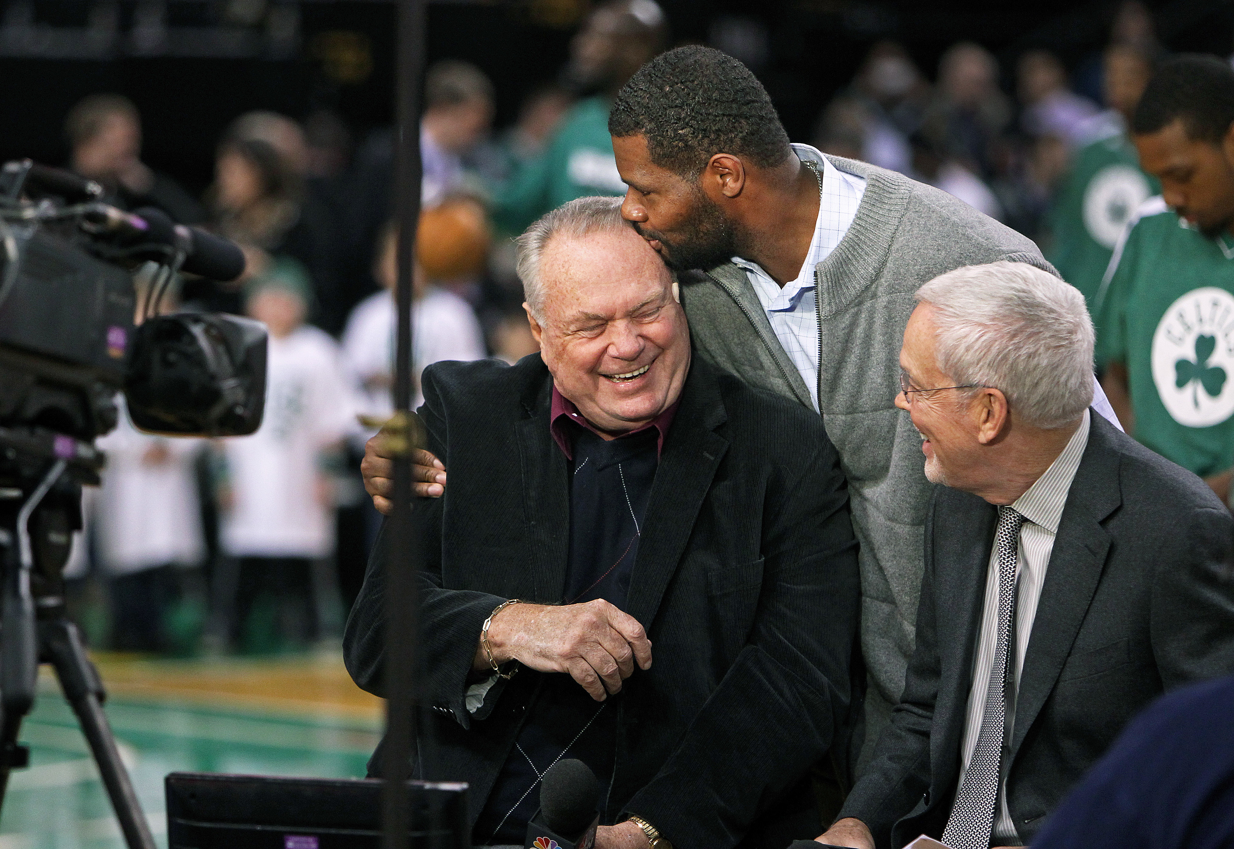 Tommy Heinsohn and his partner Mike Gorman get a pregame visit from former Celtic Walter McCarty.