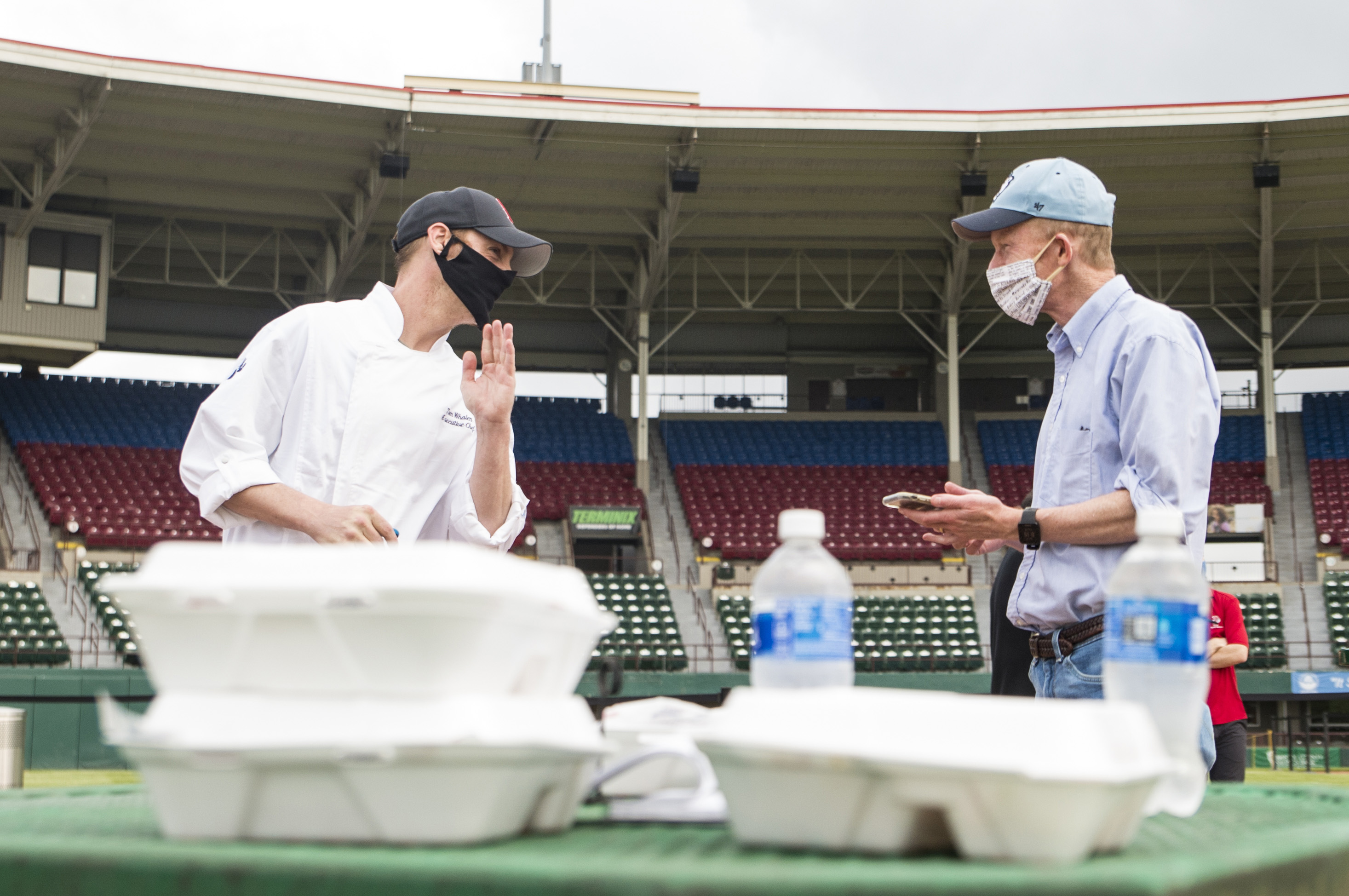 Tom Whalen, executive chef with the Pawtucket Red Sox, "whispers" to Globe reporter Edward Fitzpatrick during a press preview of "Dining on the Diamond," at McCoy Stadium.
