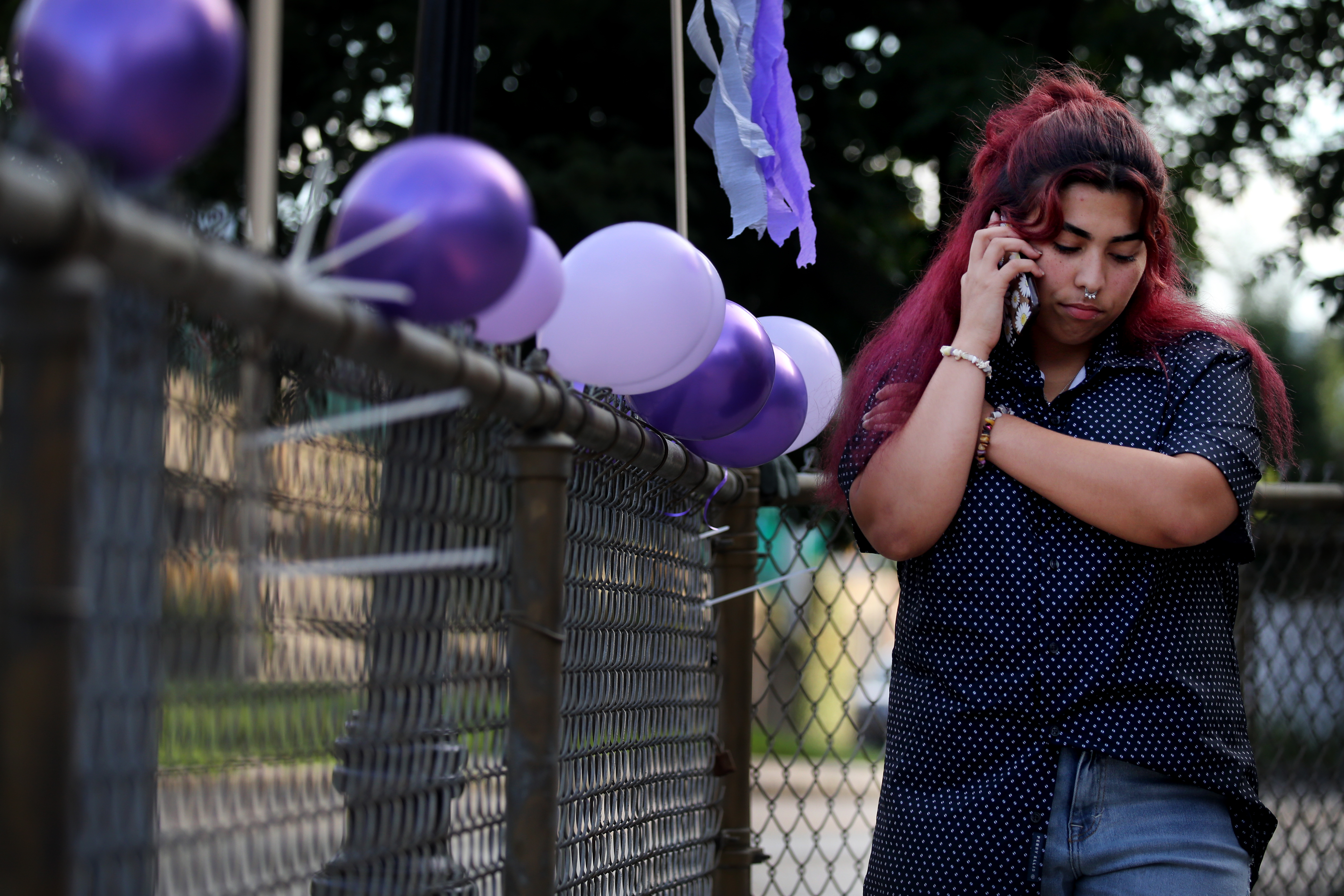 Serennity Figueroa, who struggled with mental health during the pandemic, talked to a family member during an international overdose awareness day event in Charlestown Aug. 31. Participating more in a youth program, Turn It Around, helped her recover.