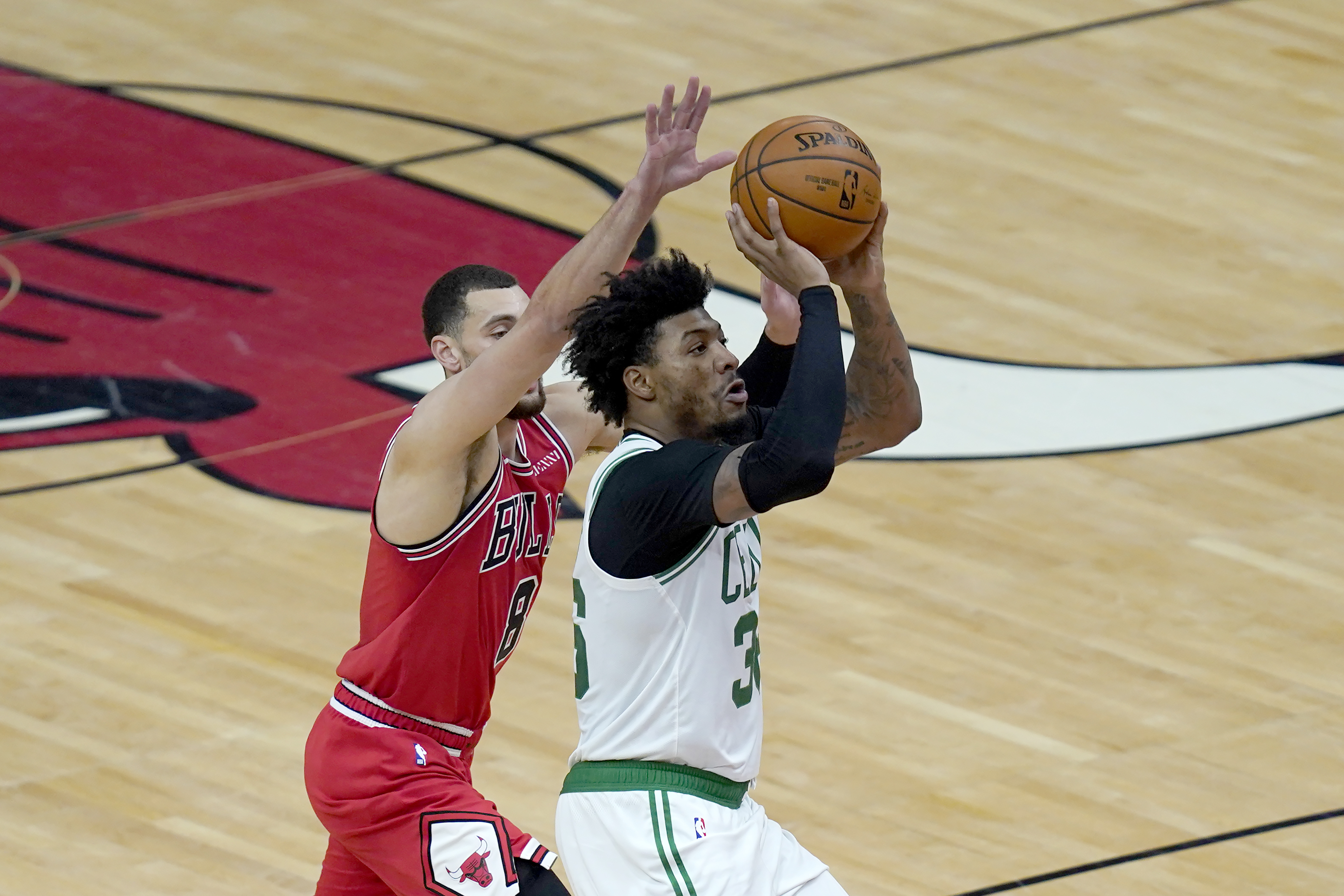 Marcus Smart shoots past Chicago's Zach LaVine during the first half of Monday's game.