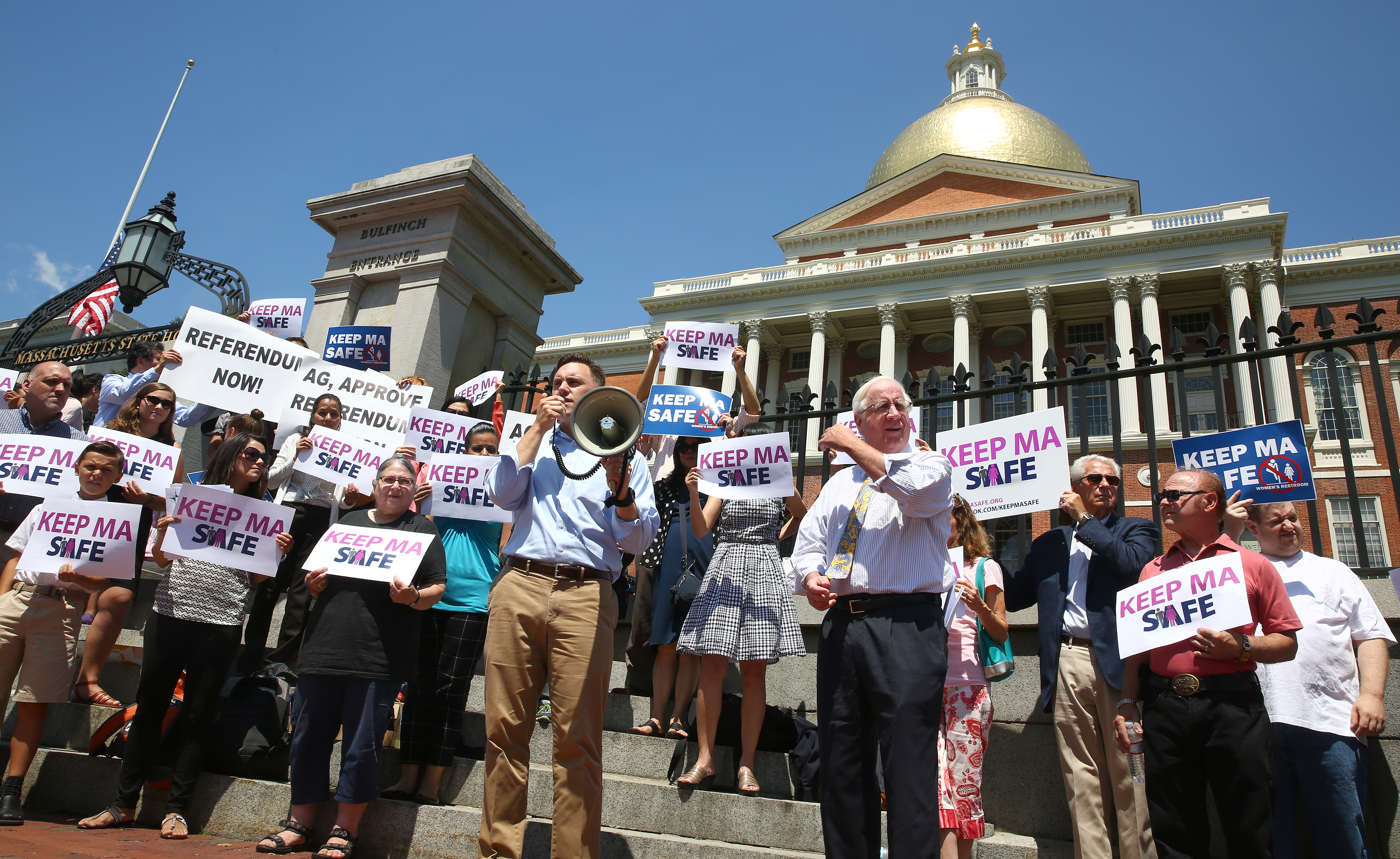 Andrew Beckwith, pictured at a rally in 2016 (holding megaphone), leads a conservative group against, as he says, “promoting transgenderism.”