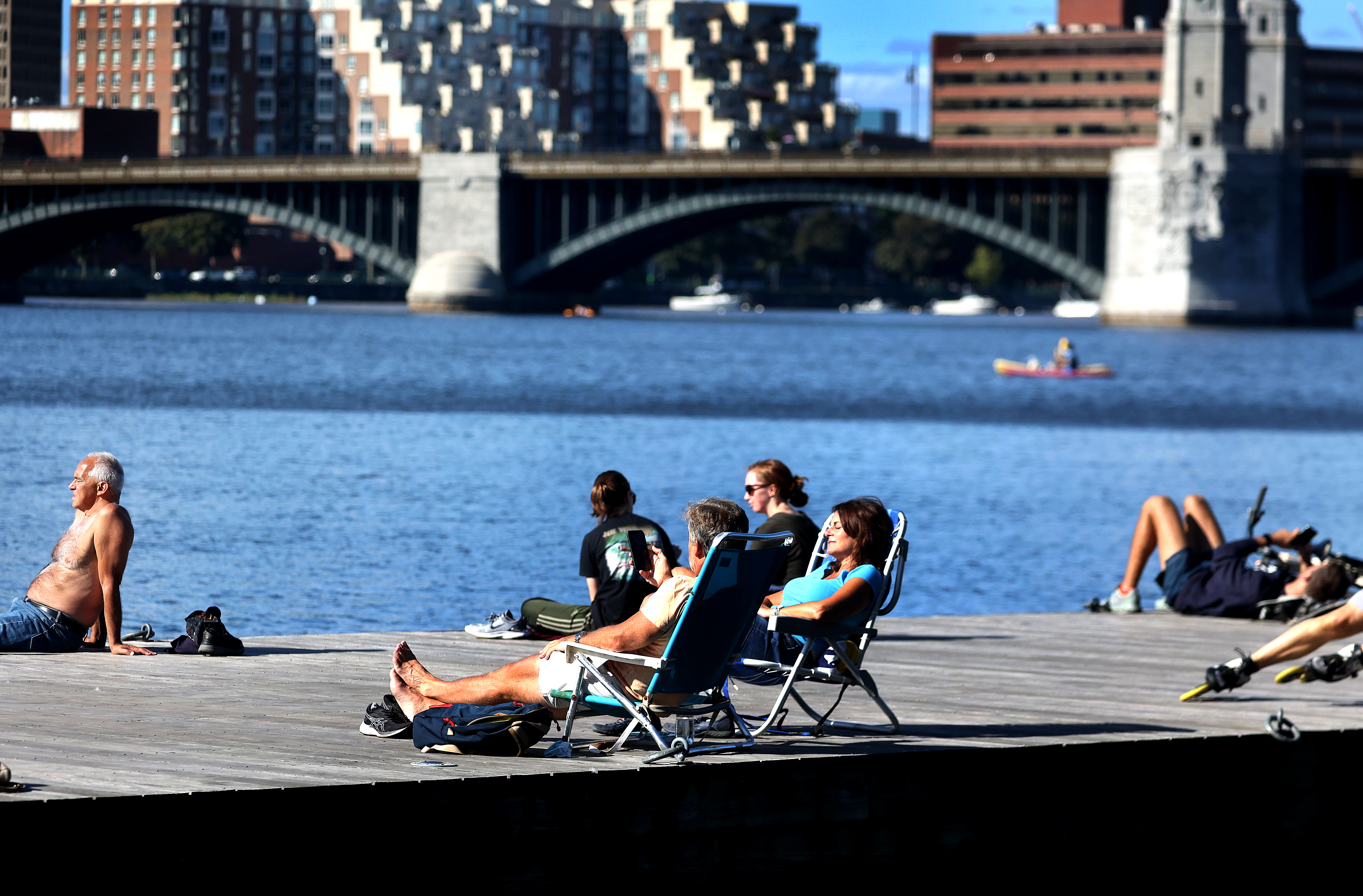 People take in the beautiful weather along the Esplanade.
