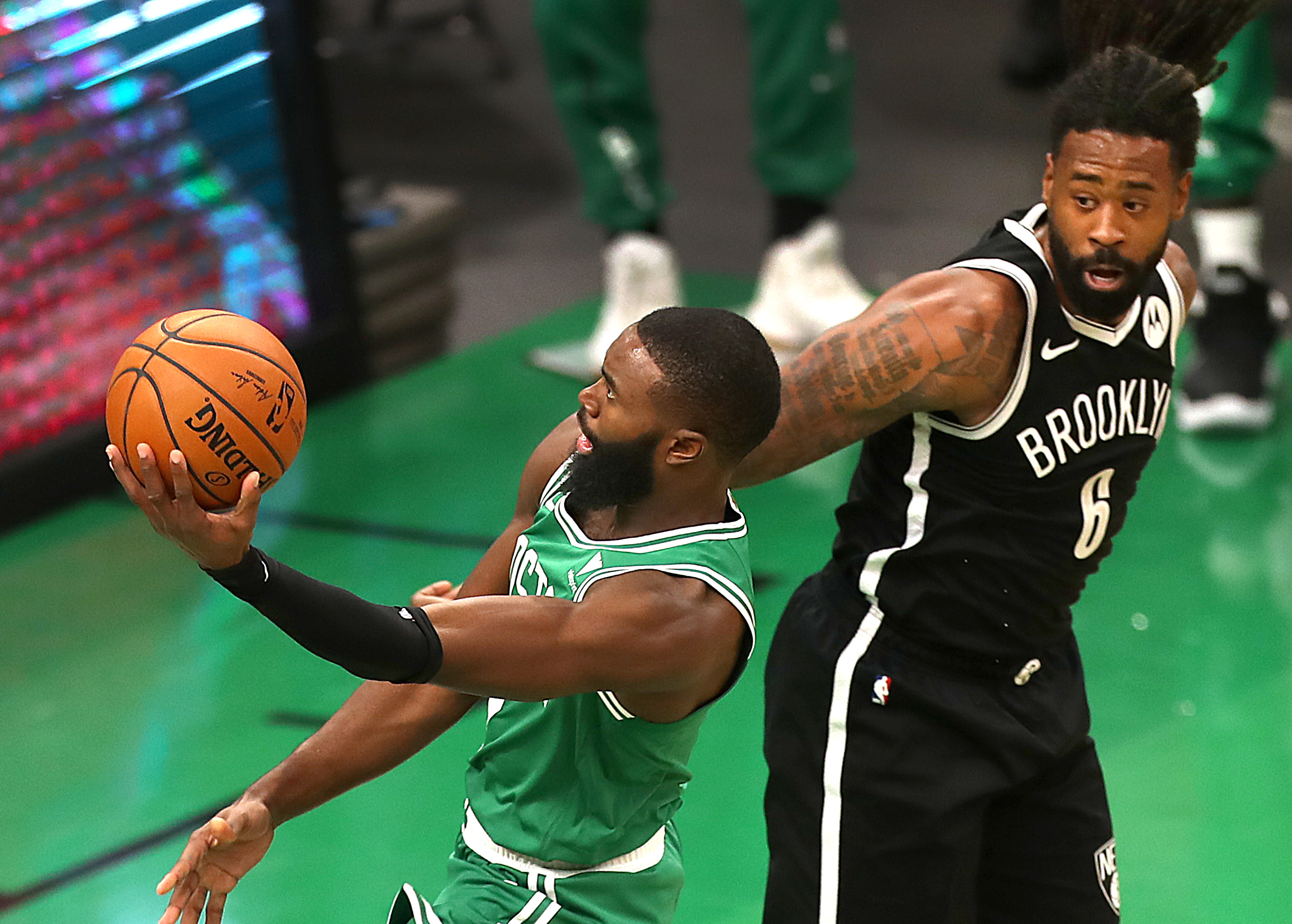 Jaylen Brown drives [against Brooklyn's DeAndre Jordan in a game at TD Garden last month.