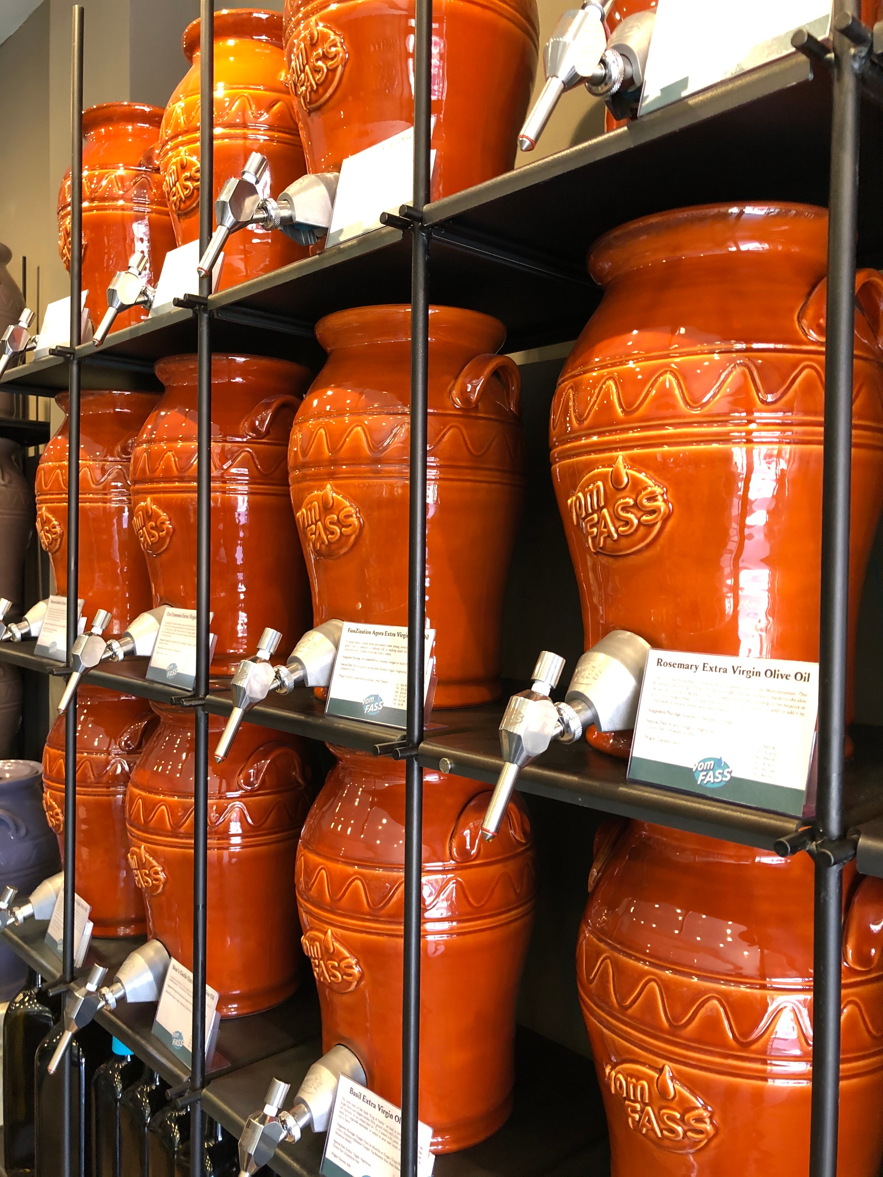 Ceramic amphoras filled with olive oils at Rue de Saveur, a new store in Brookline’s Coolidge Corner.