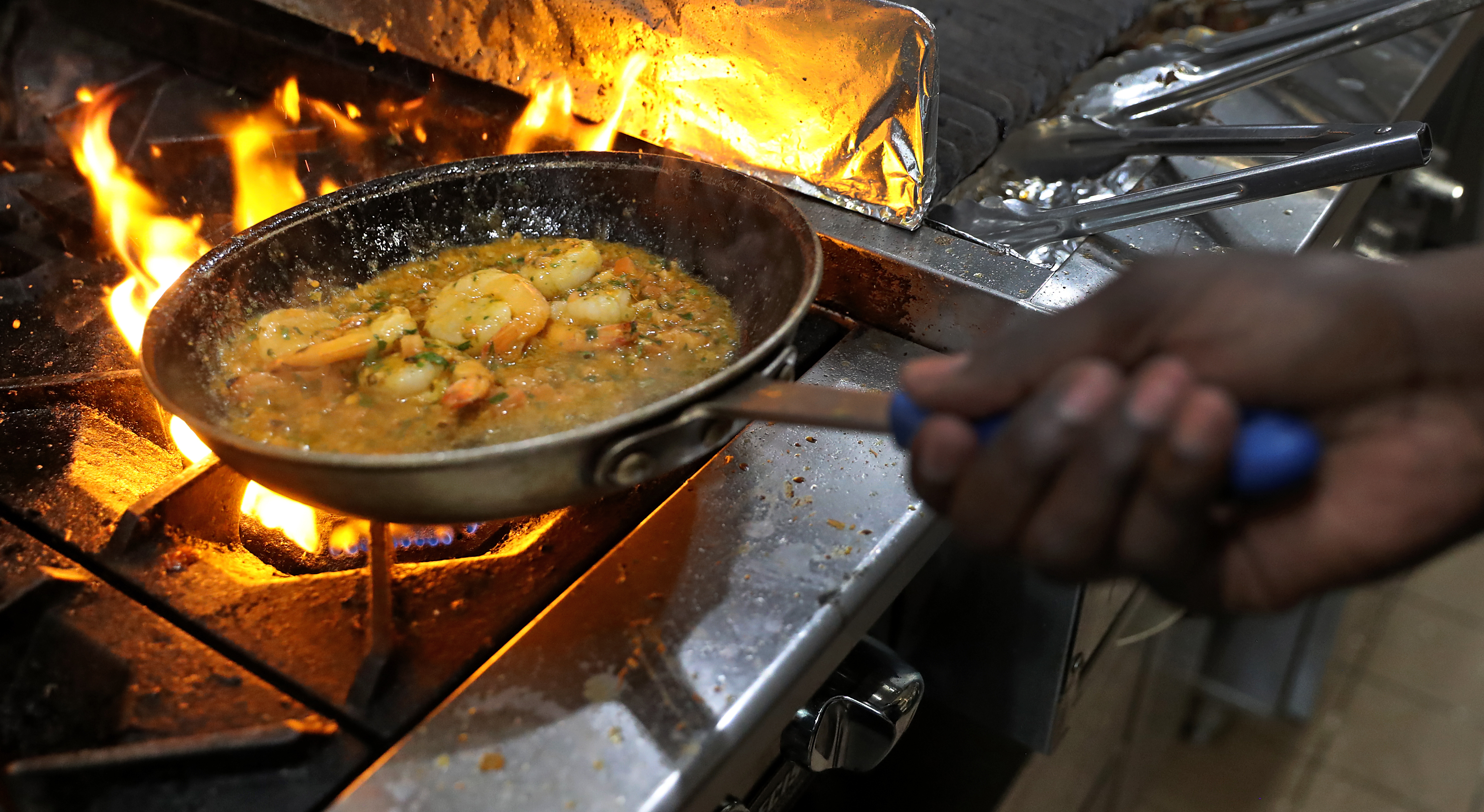 Anthony Caldwell cooks shrimp at 50Kitchen.