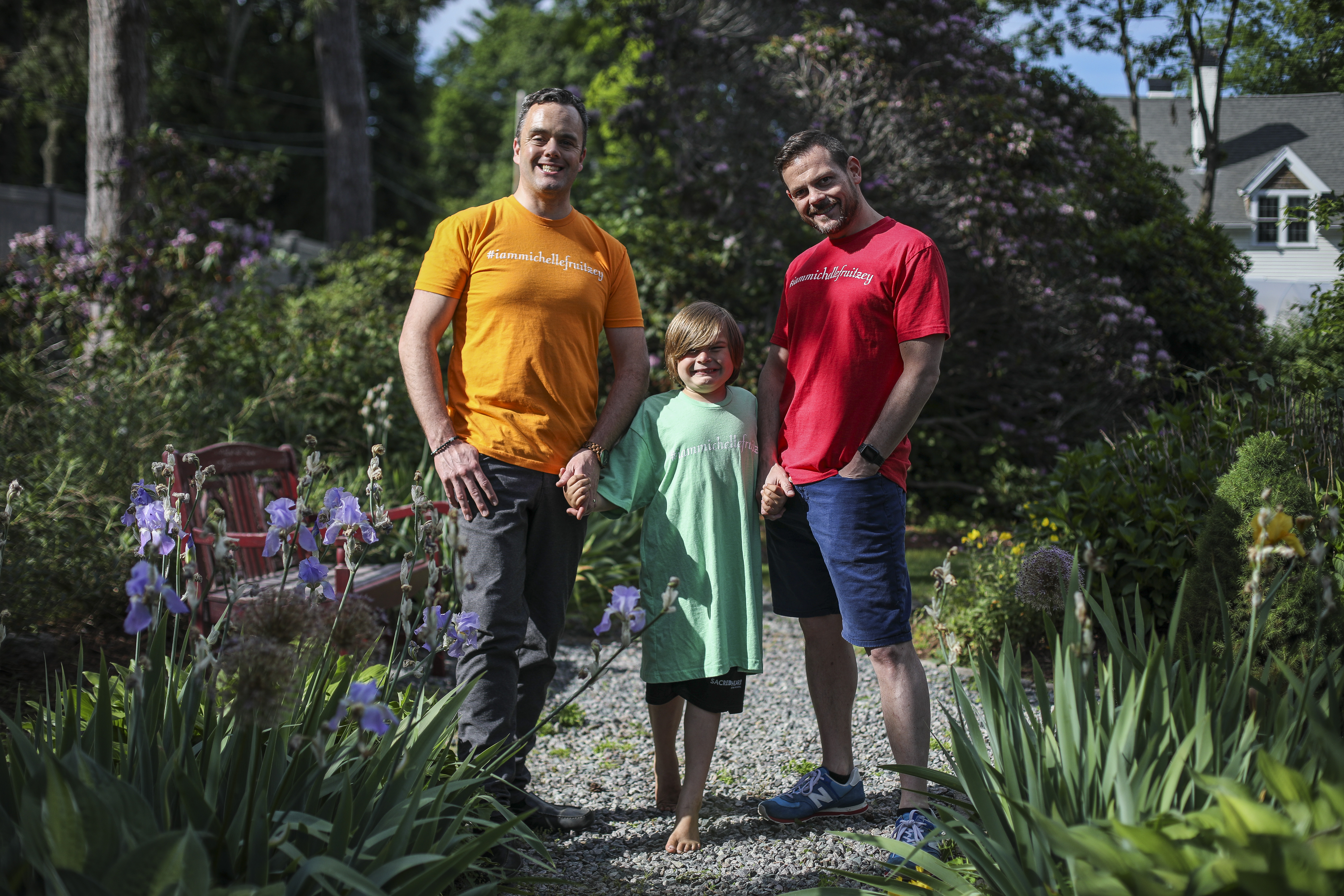 Bryan Furze (left), his partner LeeMichael McLean, and their son Simon at their Milton home.