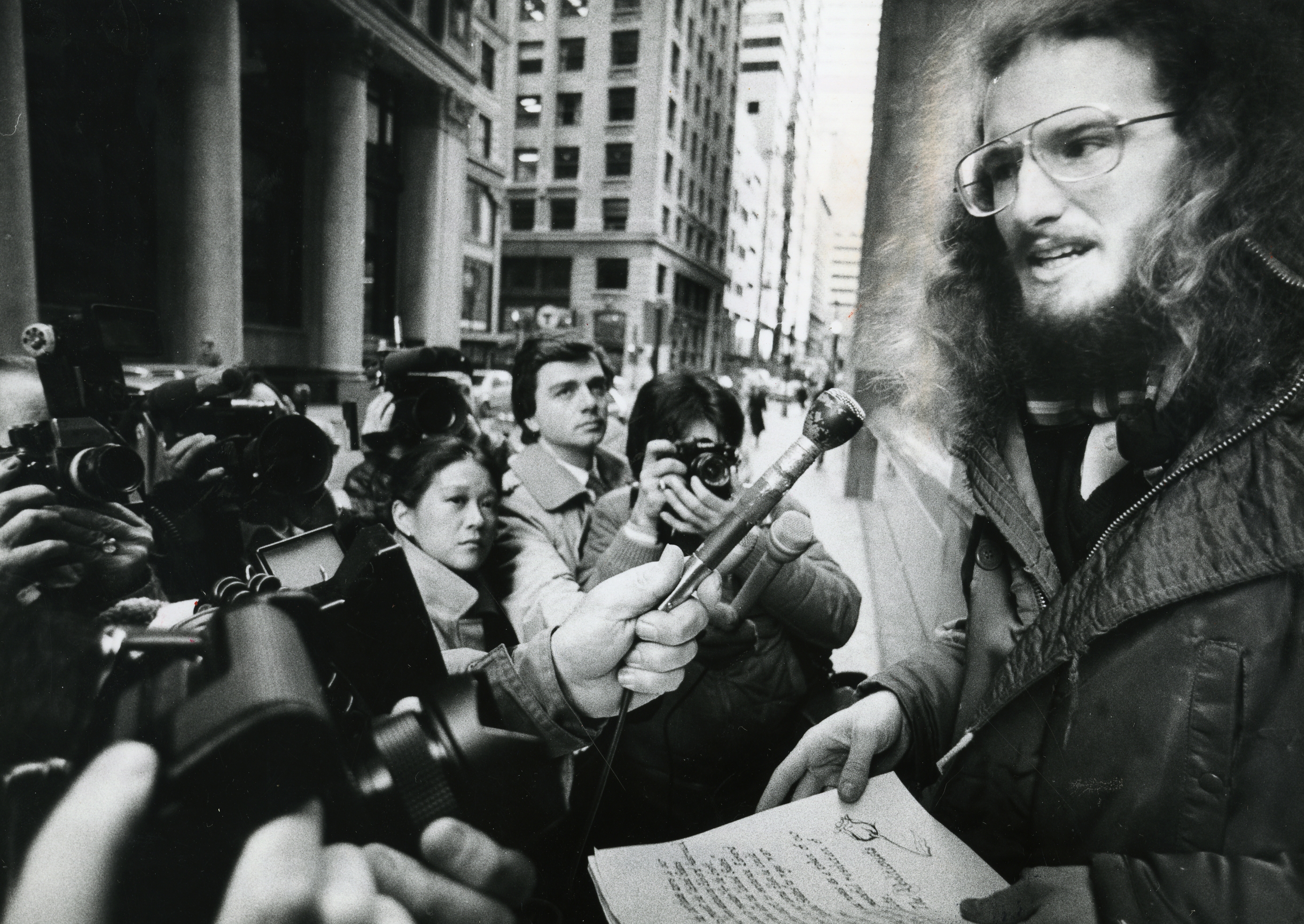 In this file photo, Edward Hasbrouck, who refused to register for the draft, talks with reporters outside federal court in Boston on Jan. 14, 1983.