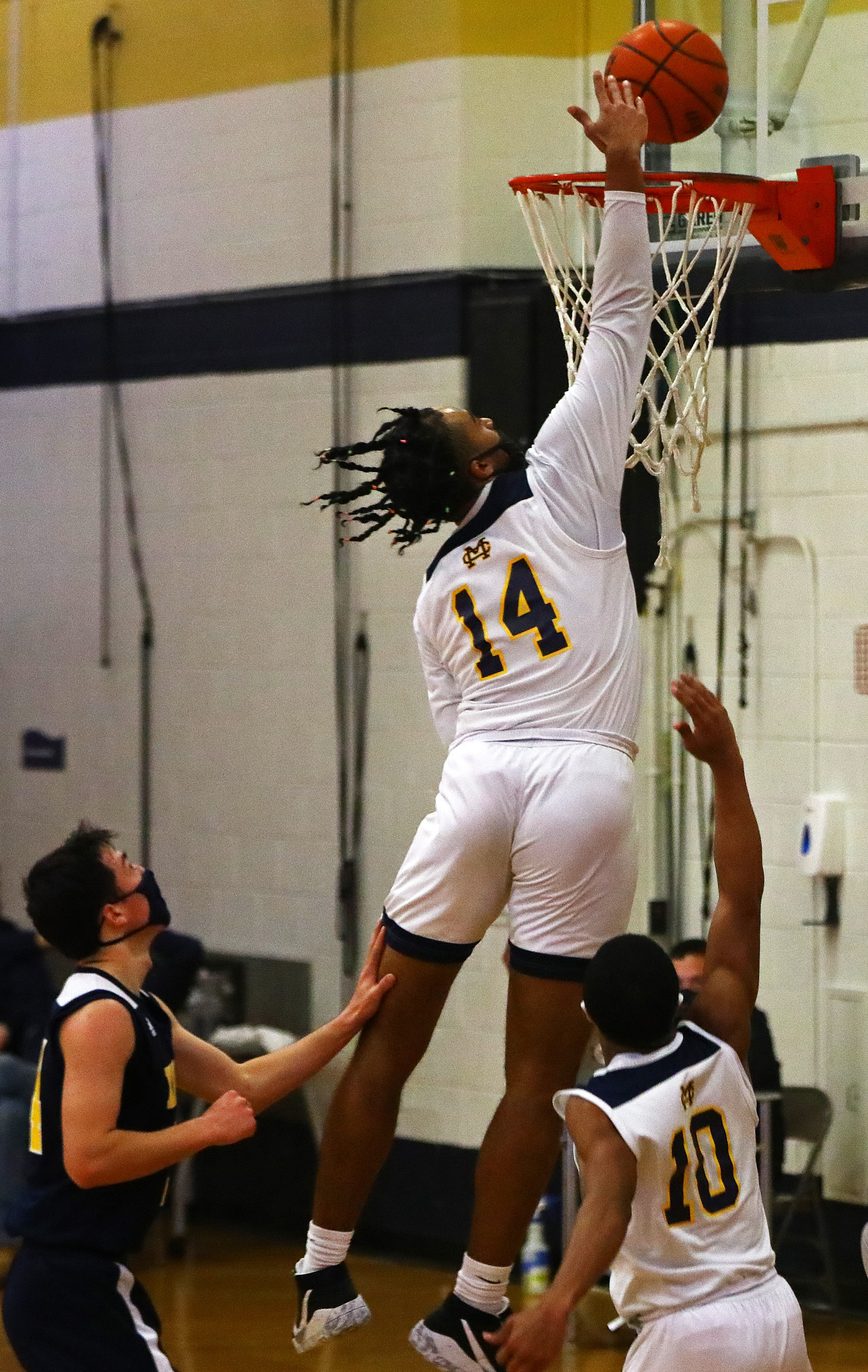 Malden Catholic's Breen Kingsley (14) soars to the rim for 2 points against Xaverian Sunday afternoon.