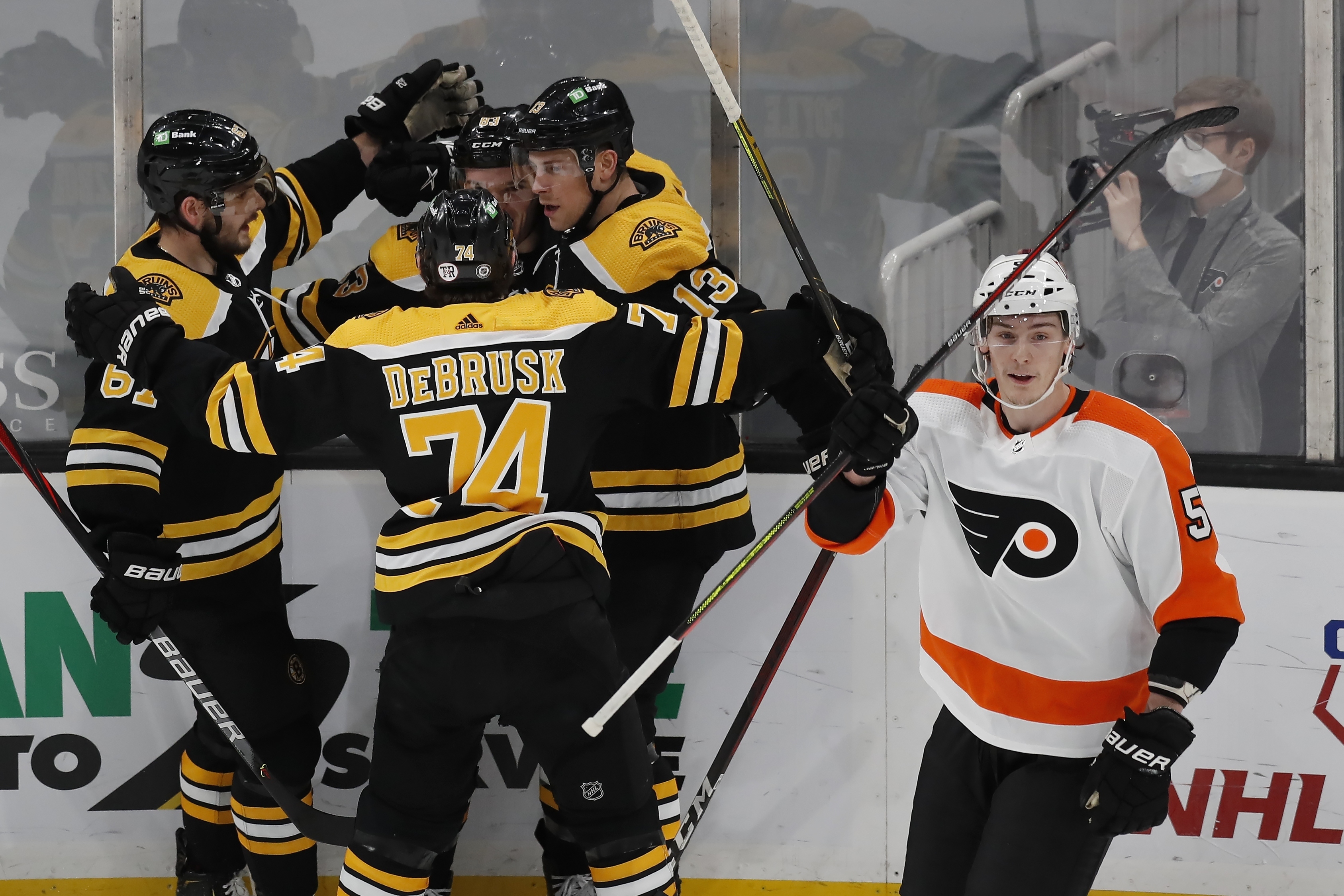 Karson Kuhlman celebrates his goal with teammates Jakub Zboril, Jake DeBrusk and Charlie Coyle during the first period of Monday's game.