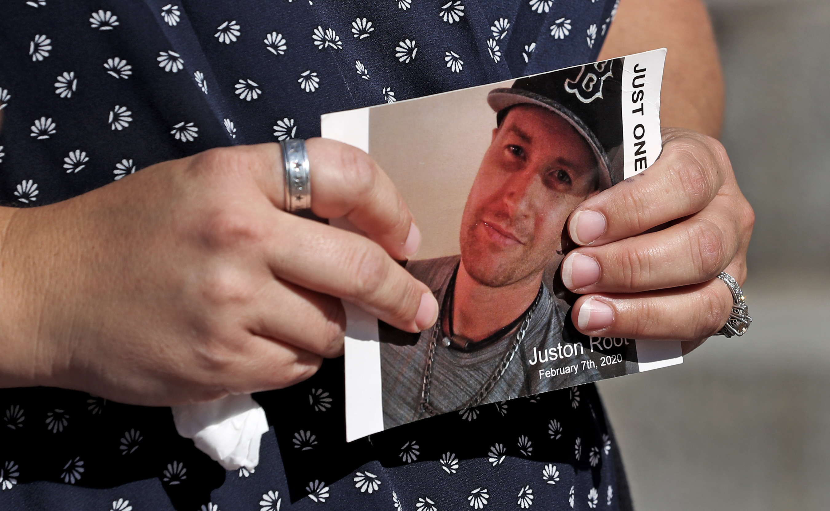Jennifer Root Bannon held a photograph of her brother, Juston Root, who was killed by Boston Police on Feb. 7 after an incident at the Brigham and Women's Hospital.