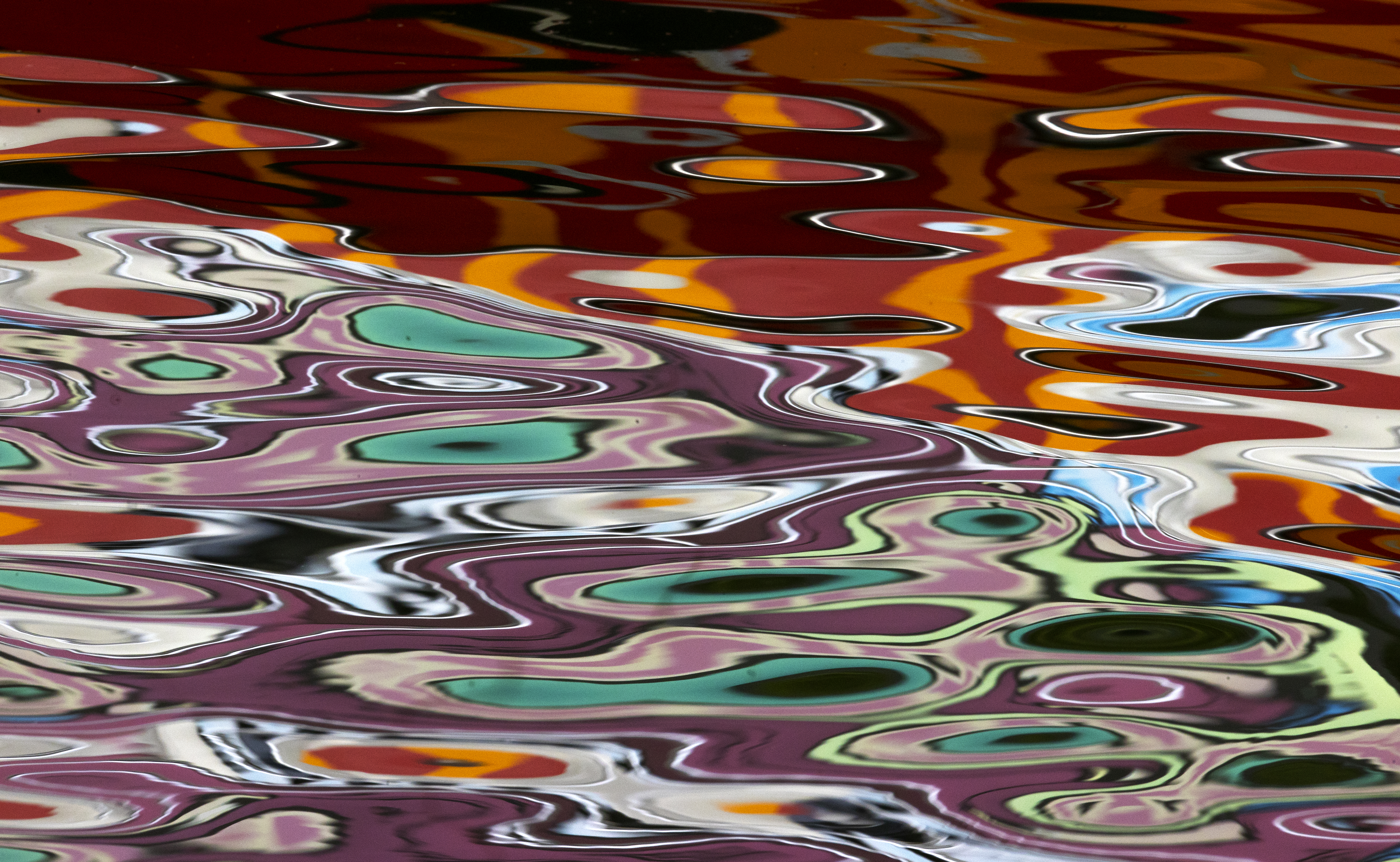 The waters of Boston Harbor offered a multicolored palette, reflecting the passage of a boat offering tours.